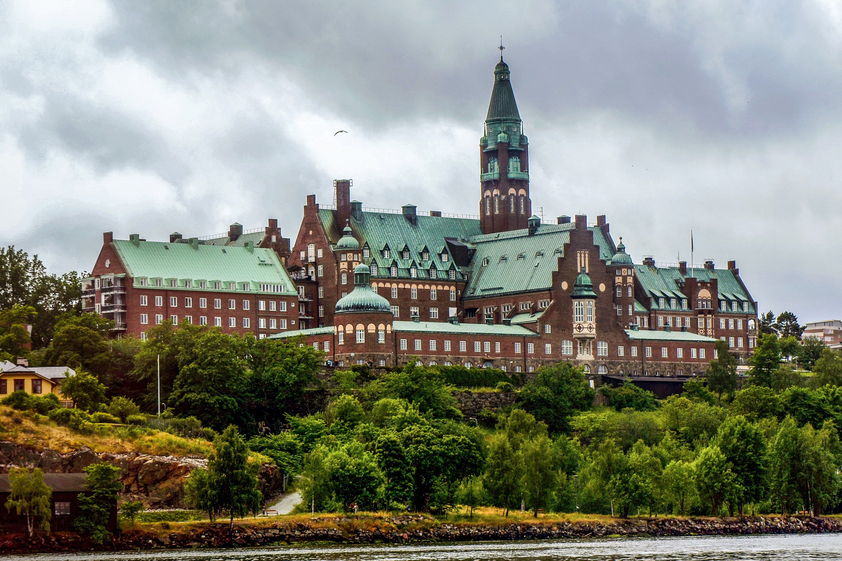 Large brick building with green roofs in Stockholm, Sweden HD Wallpaper