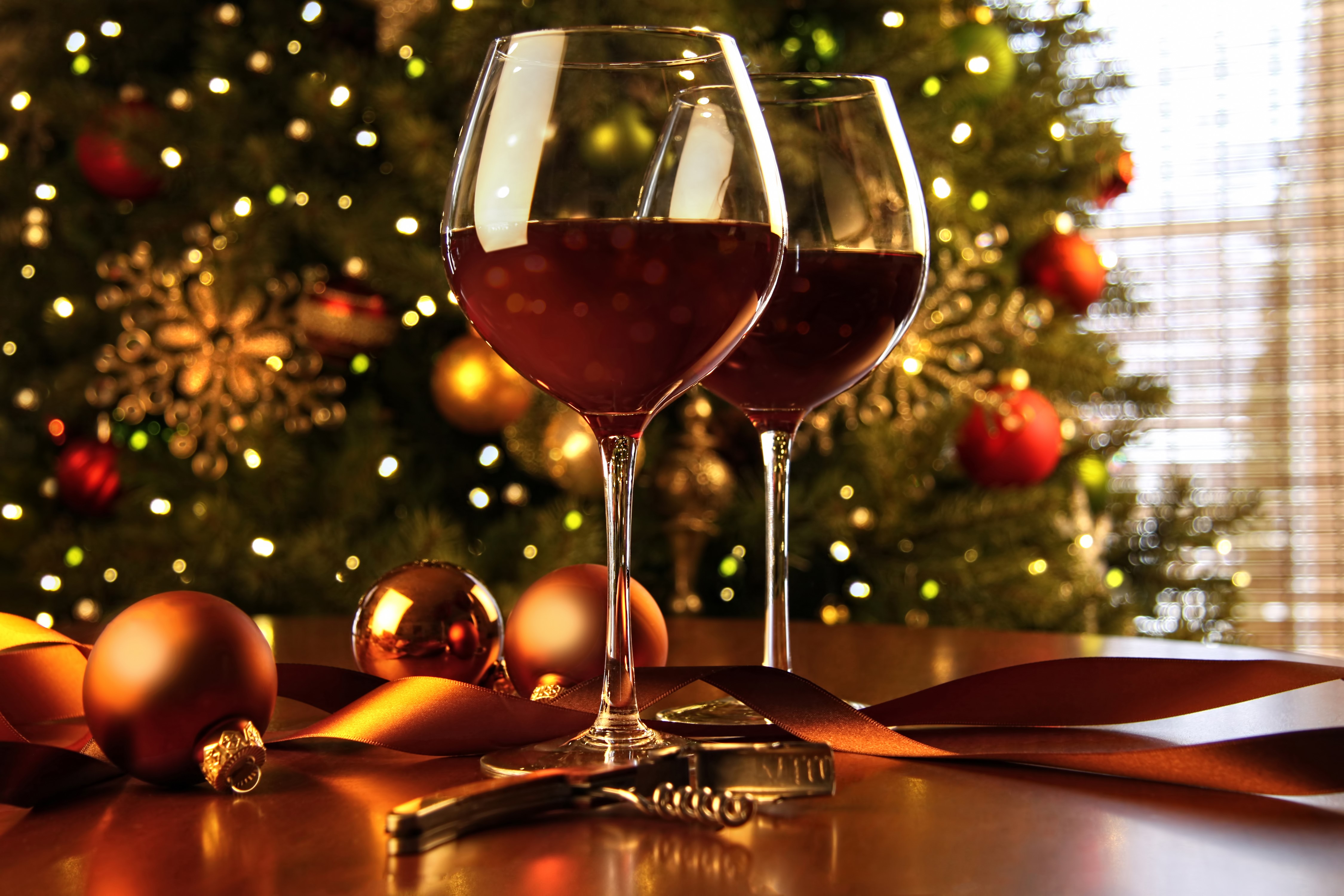 Two glasses of red wine with Christmas tree and ornaments HD Wallpaper