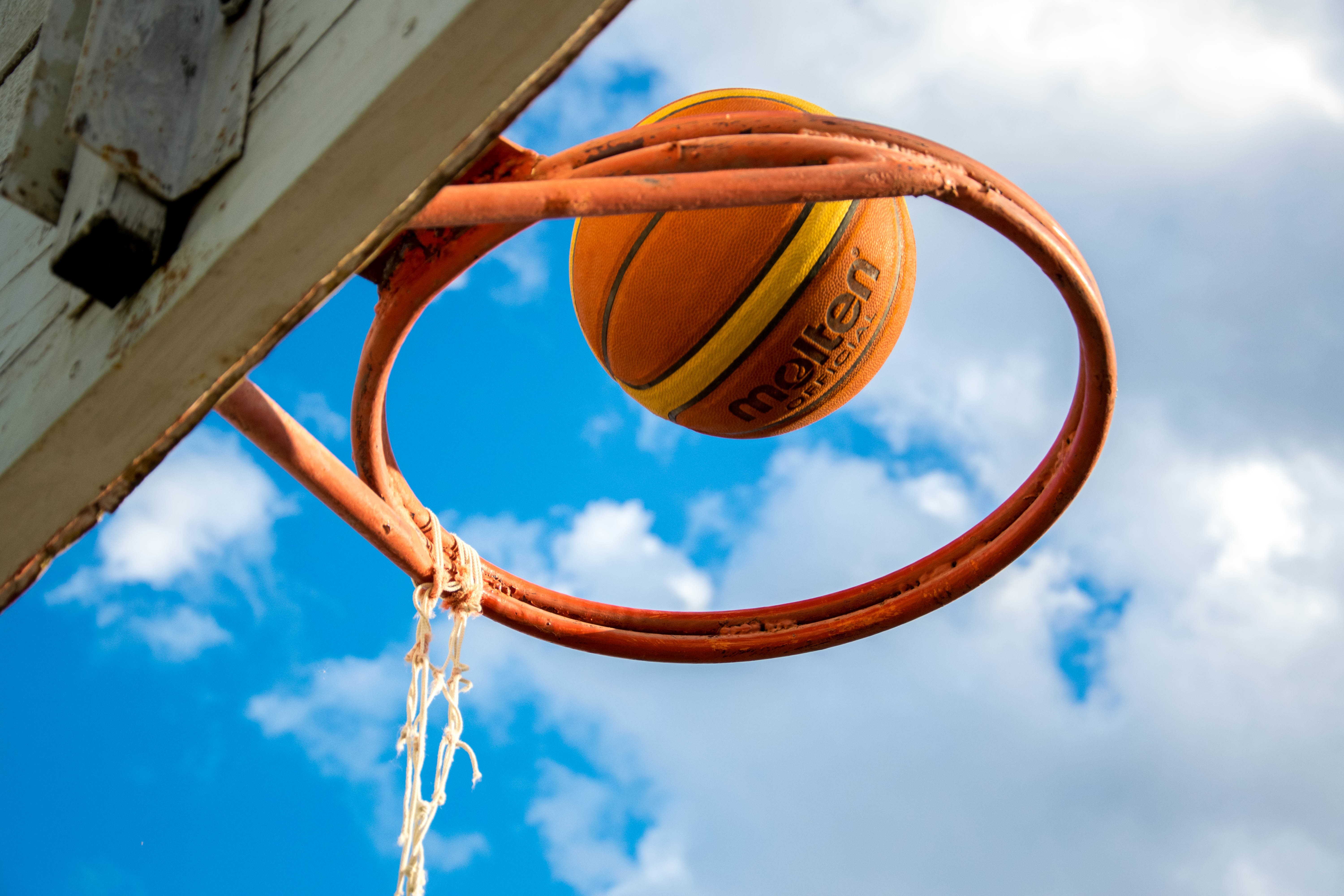 Basketball going through a hoop HD Wallpaper