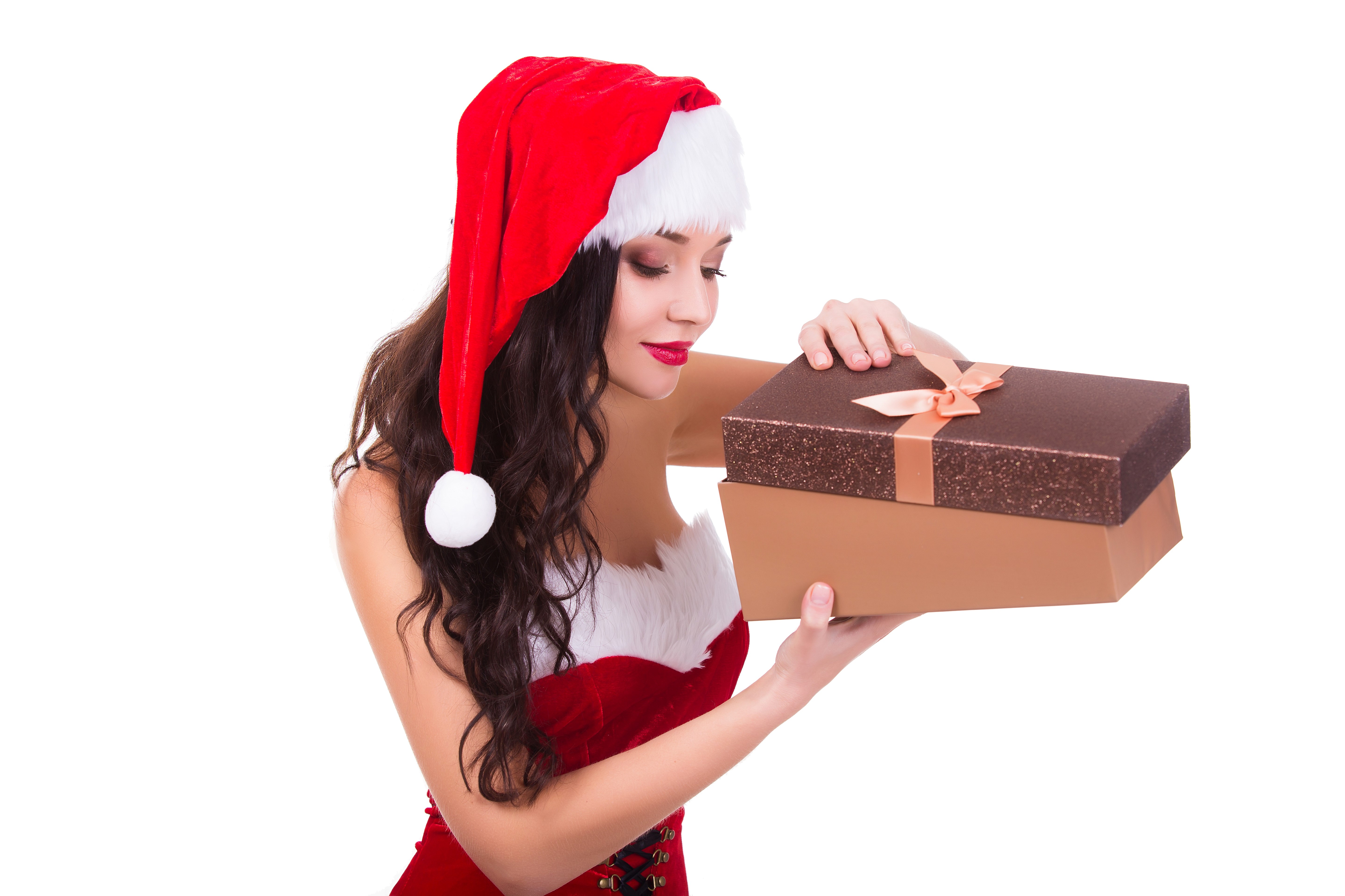 Woman in Santa hat holding Christmas gifts HD Wallpaper