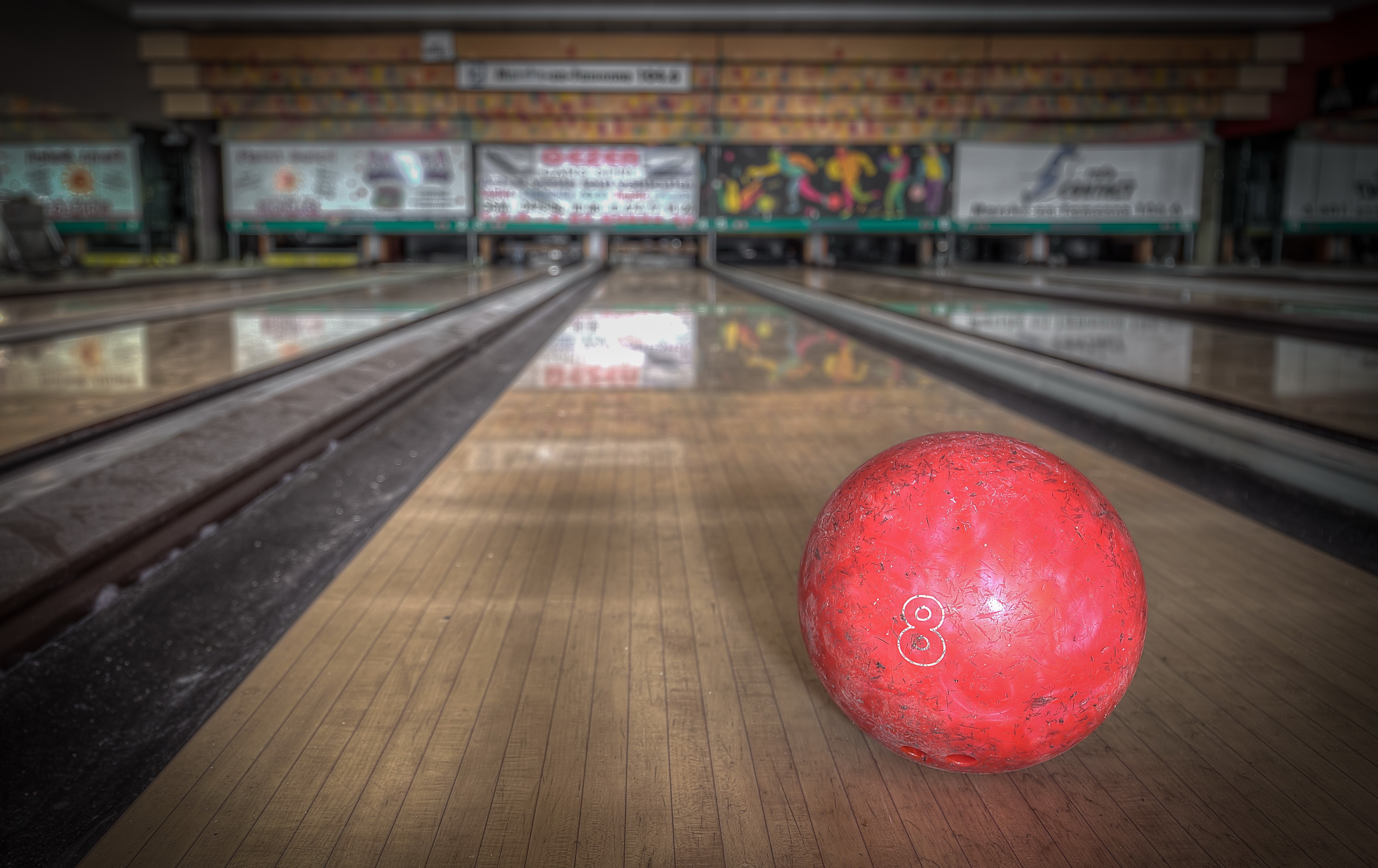 Red bowling ball on a lane HD Wallpaper