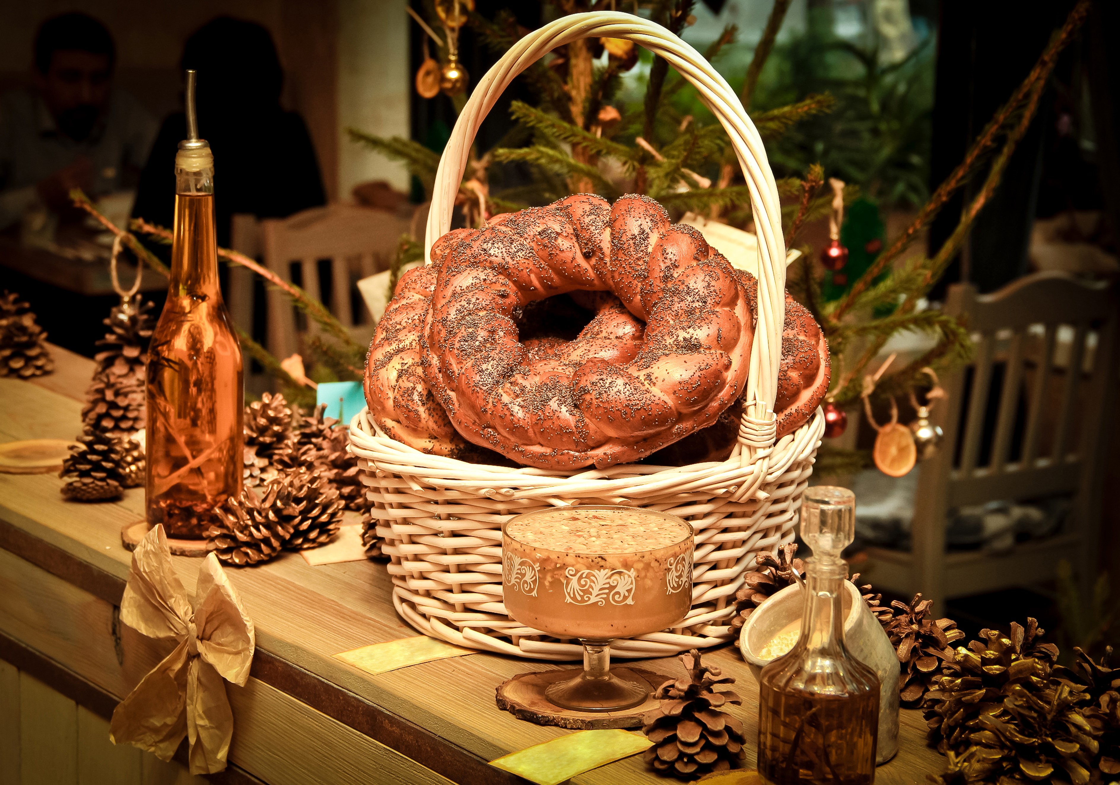 Christmas pastries in a basket with pine cones and bottles HD Wallpaper
