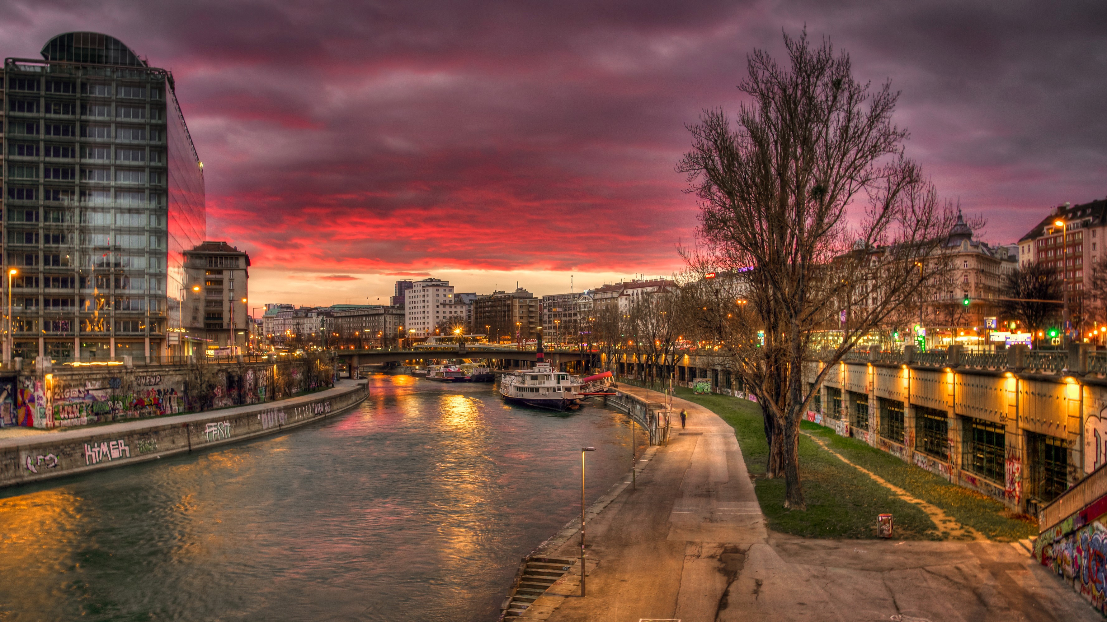 Vienna canal at sunset with buildings and boats HD Wallpaper