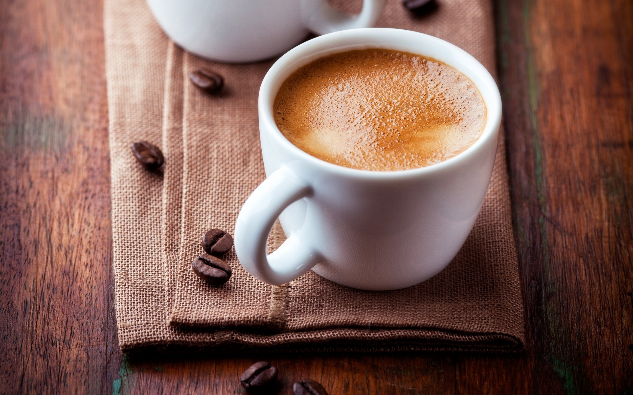 Espresso coffee in a white cup with coffee beans HD Wallpaper