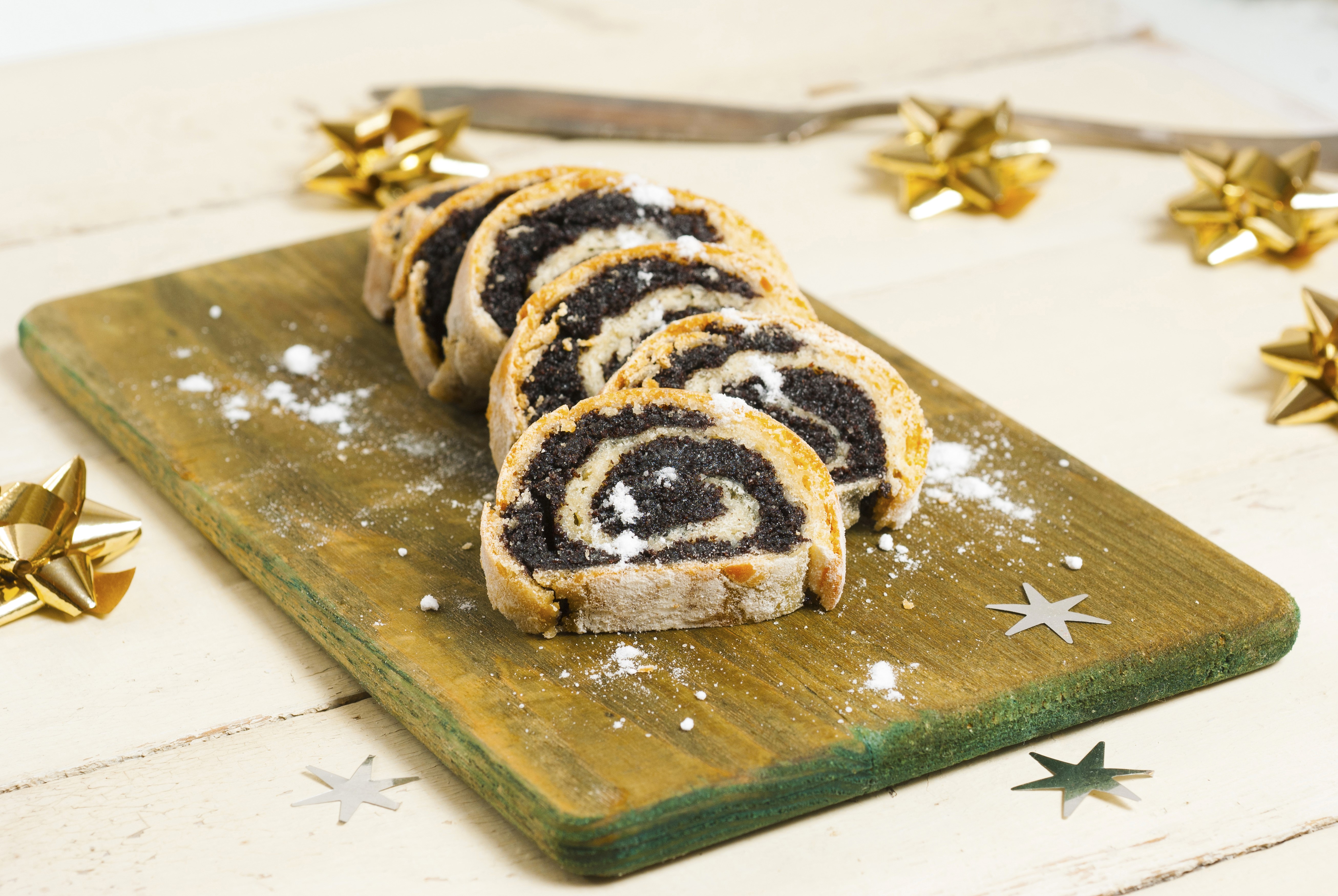 Poppy seed Swiss roll slices on a cutting board HD Wallpaper