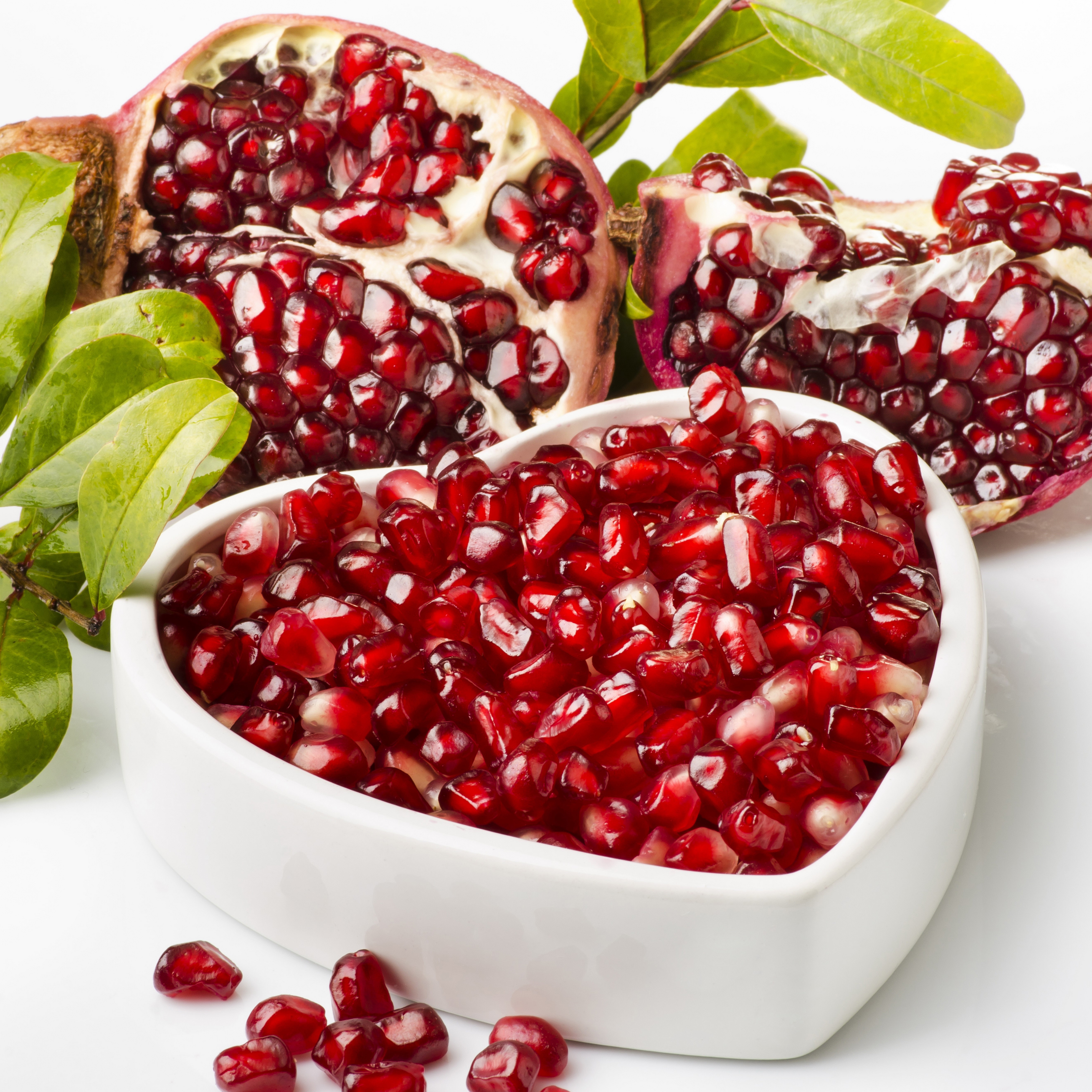 Pomegranate seeds in a heart-shaped bowl HD Wallpaper