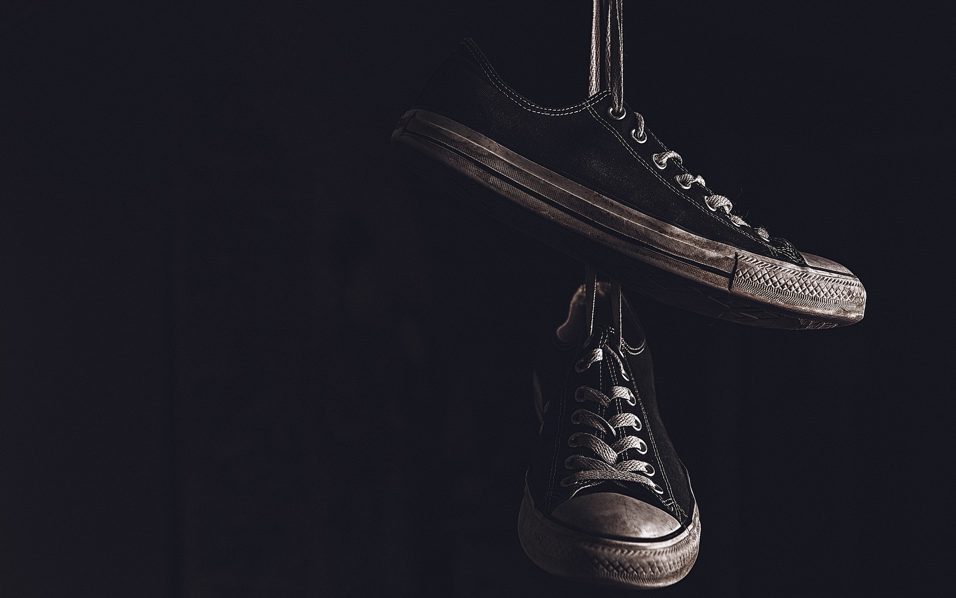 Pair of black Converse shoes hanging HD Wallpaper