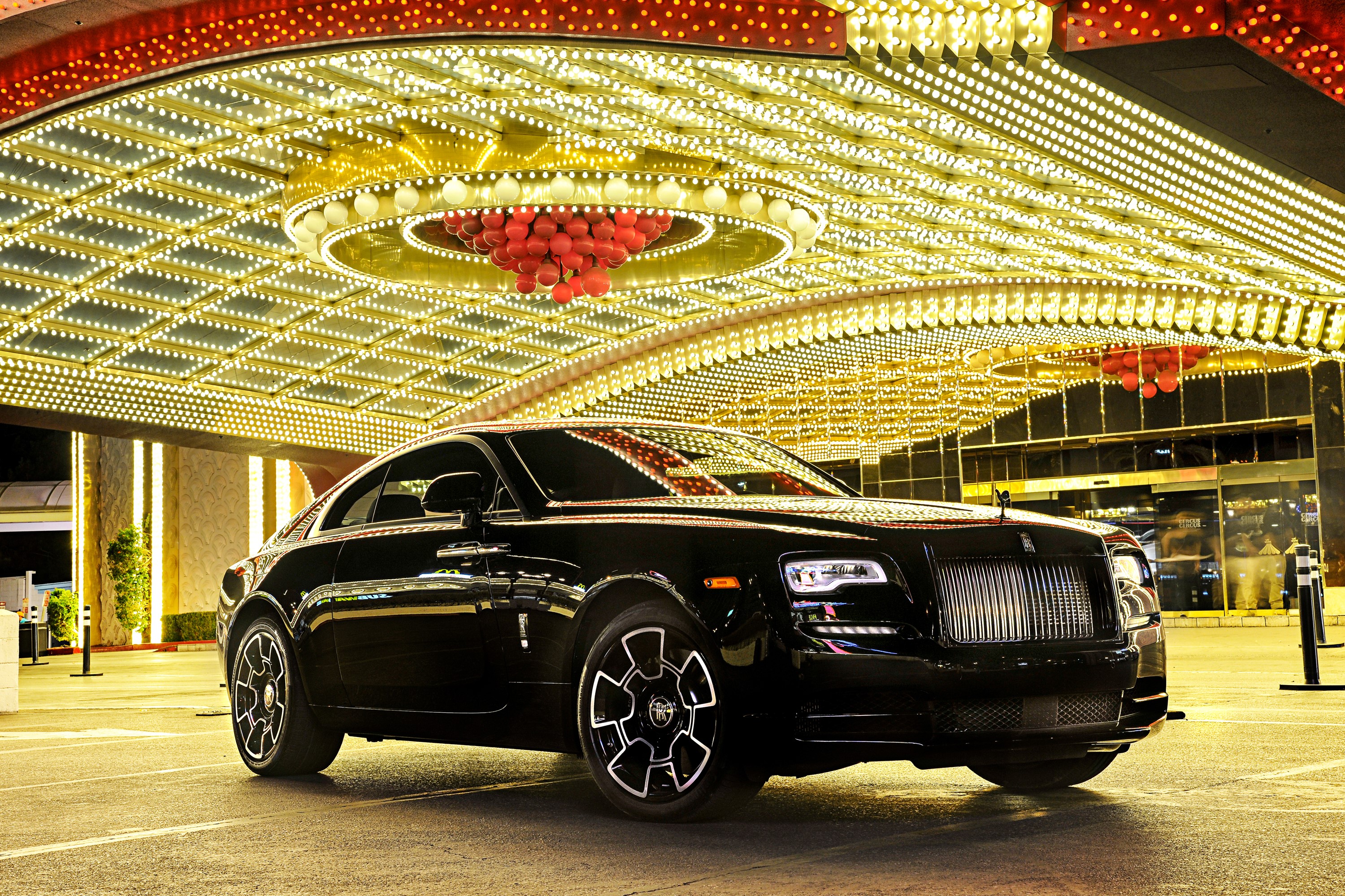 Rolls-Royce Wraith Black Badge parked under casino lights HD Wallpaper