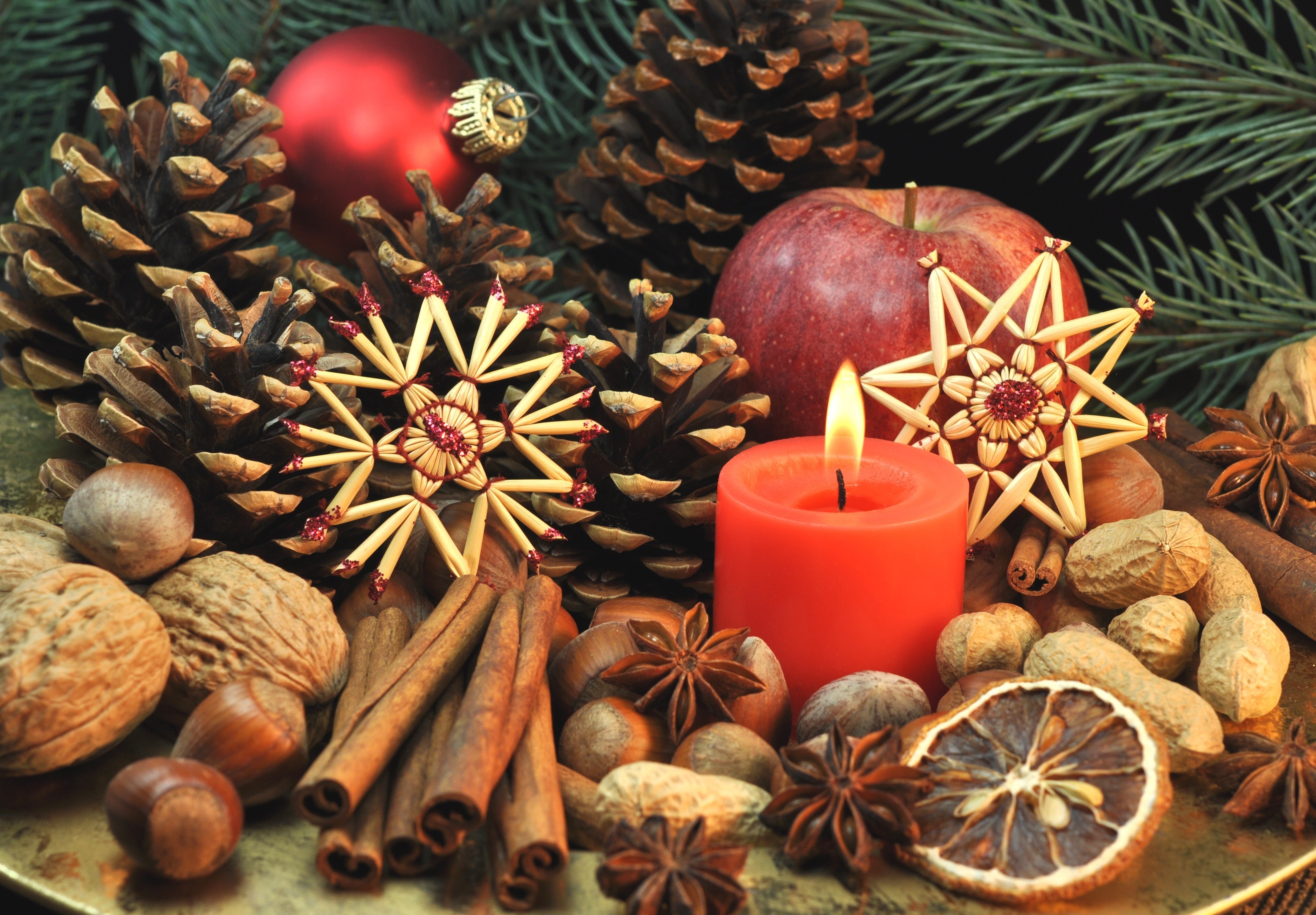 Christmas still life with candle, pine cones, and nuts HD Wallpaper