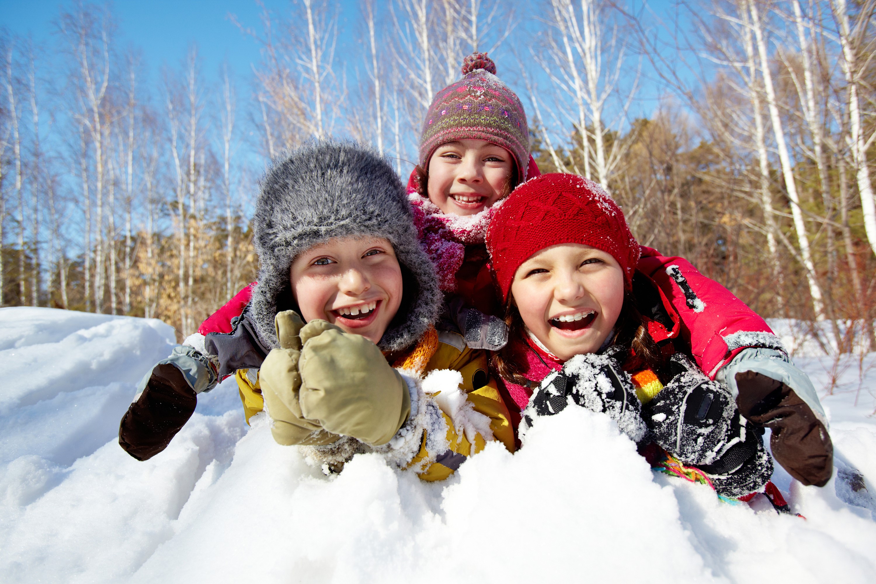 Three happy children in the snow HD Wallpaper
