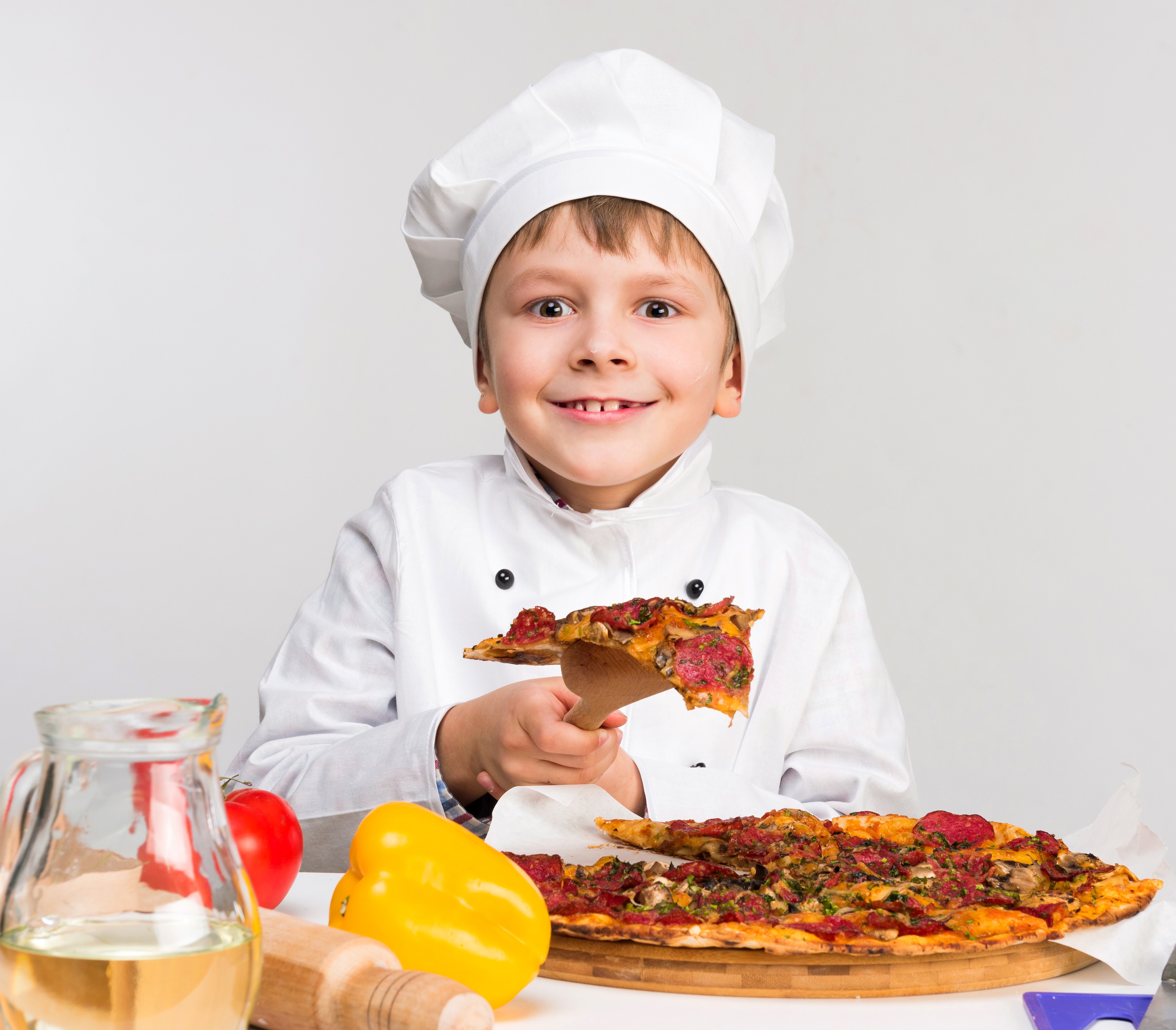 Boy in Chef's Hat Holding Pizza Slice HD Wallpaper