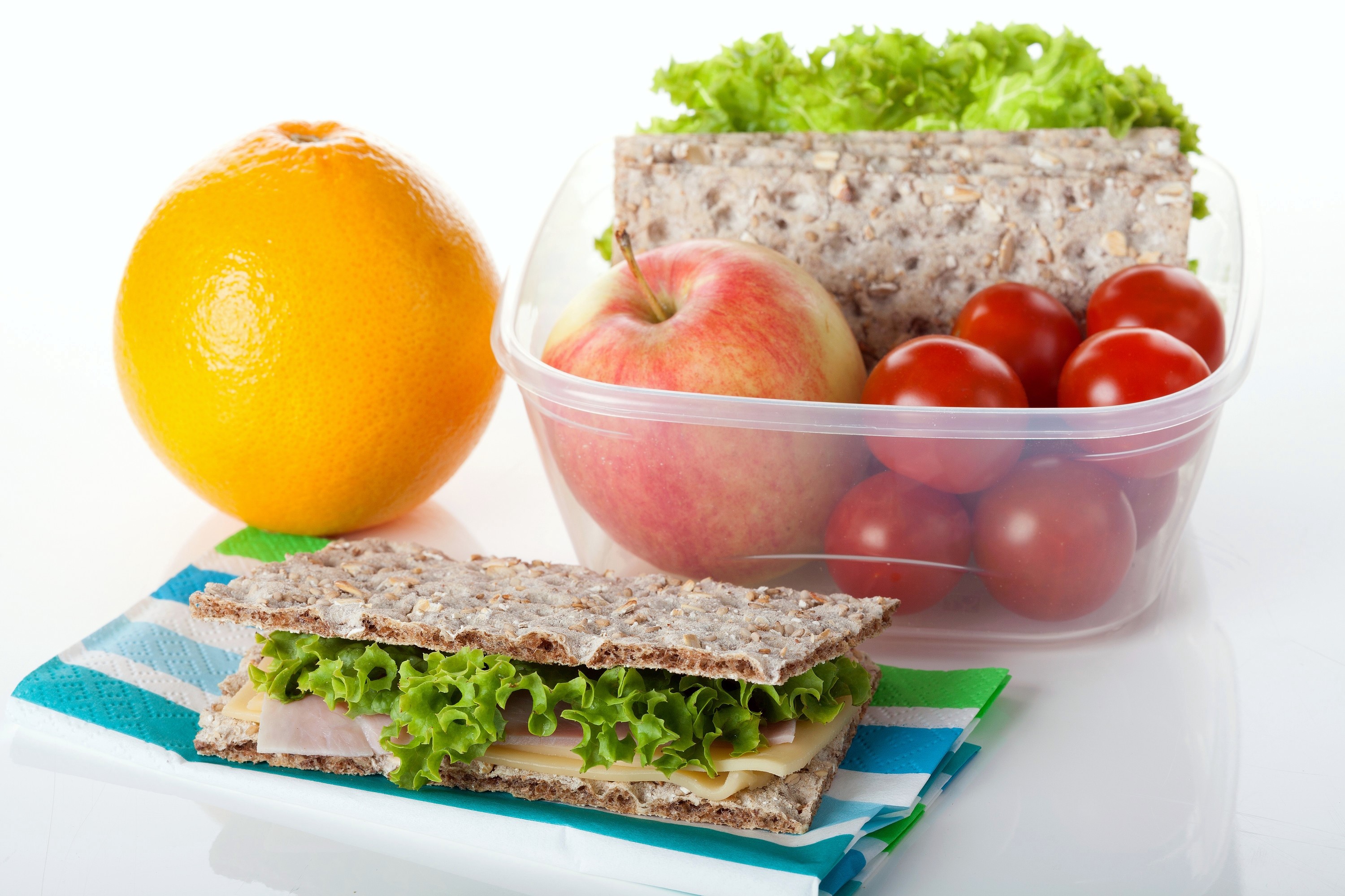 Lunchbox with sandwich, apple, orange, and tomatoes HD Wallpaper