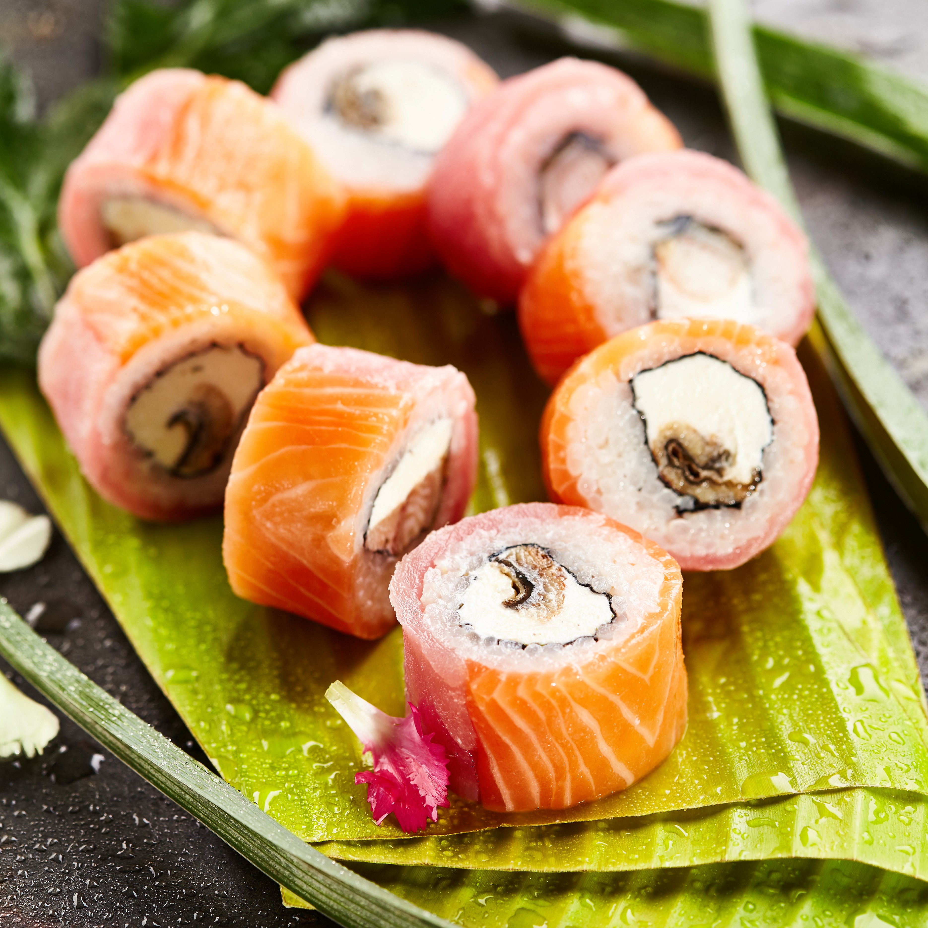 Salmon cream cheese sushi rolls on a banana leaf HD Wallpaper