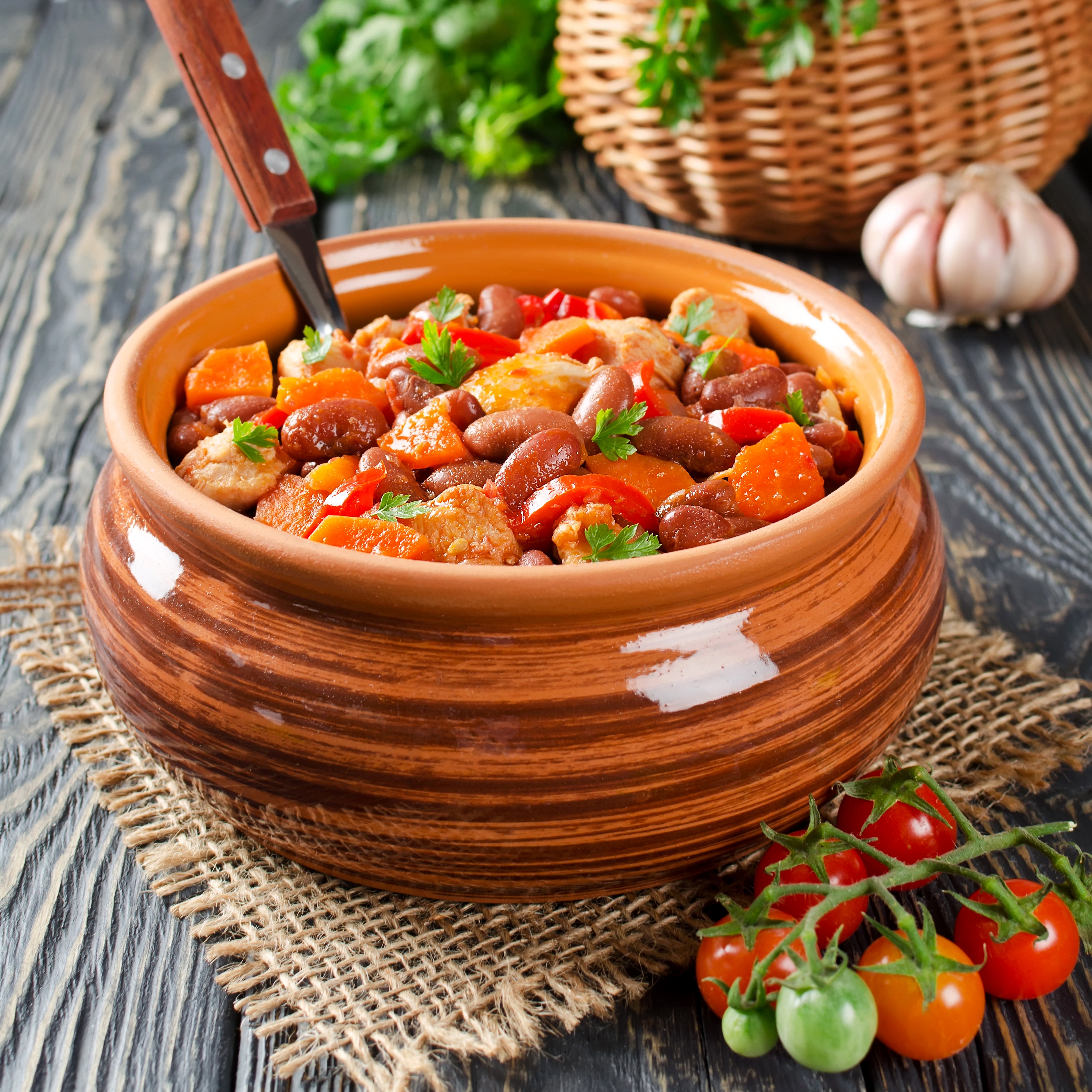 Hearty Stew in a Clay Pot with Tomatoes and Garlic HD Wallpaper