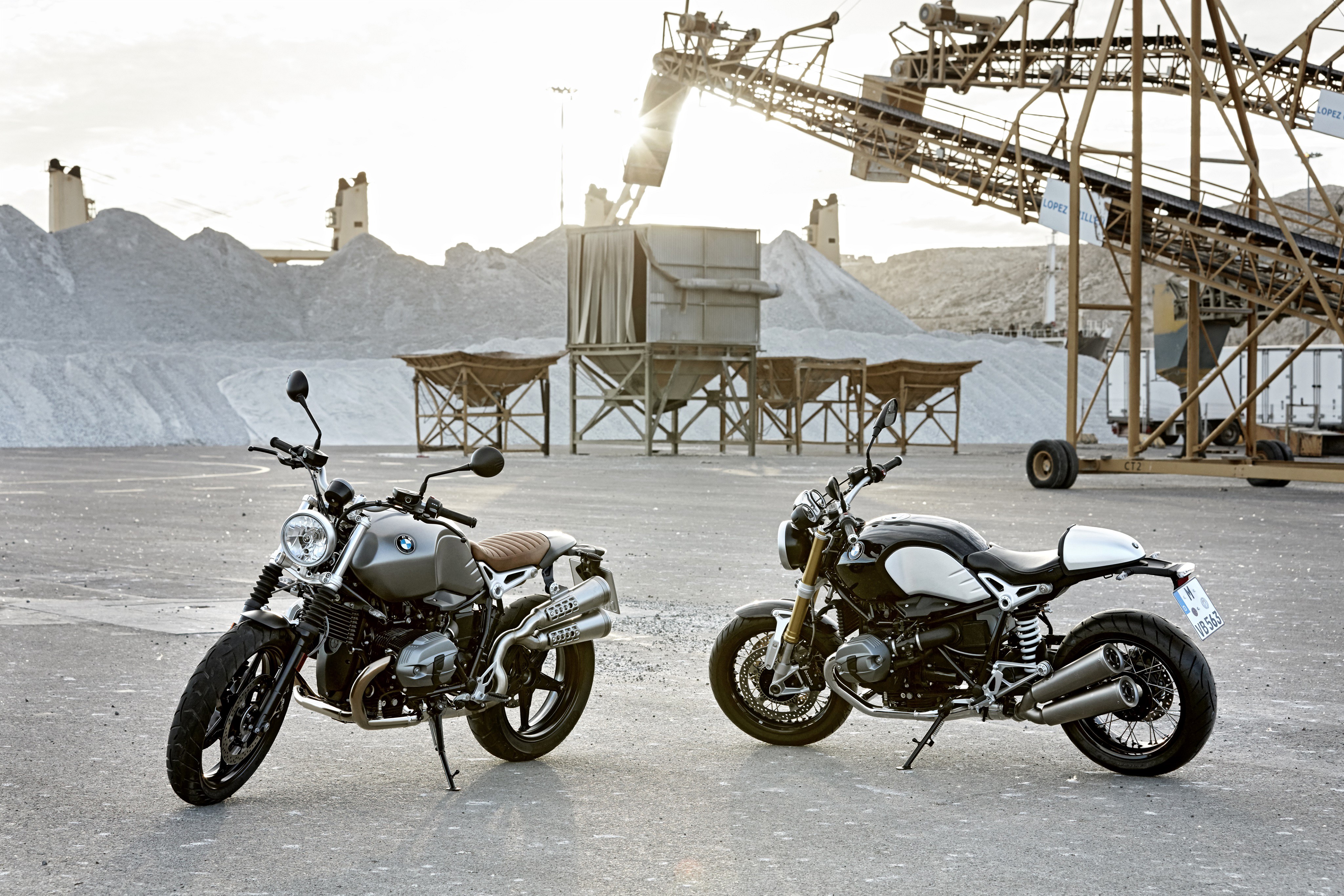 Two BMW R nine T motorcycles at industrial site HD Wallpaper
