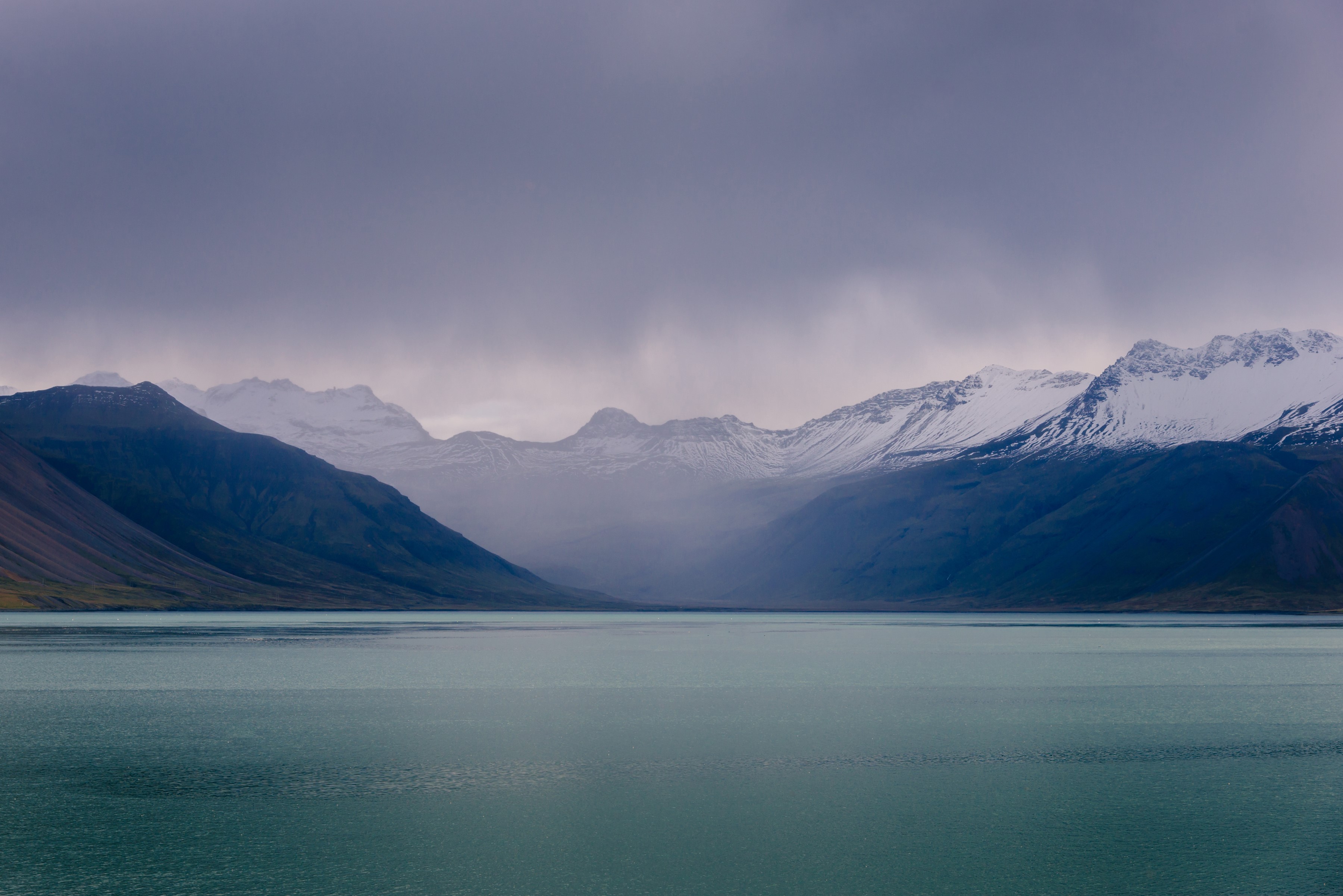 Mountains and lake in Iceland under cloudy sky HD Wallpaper
