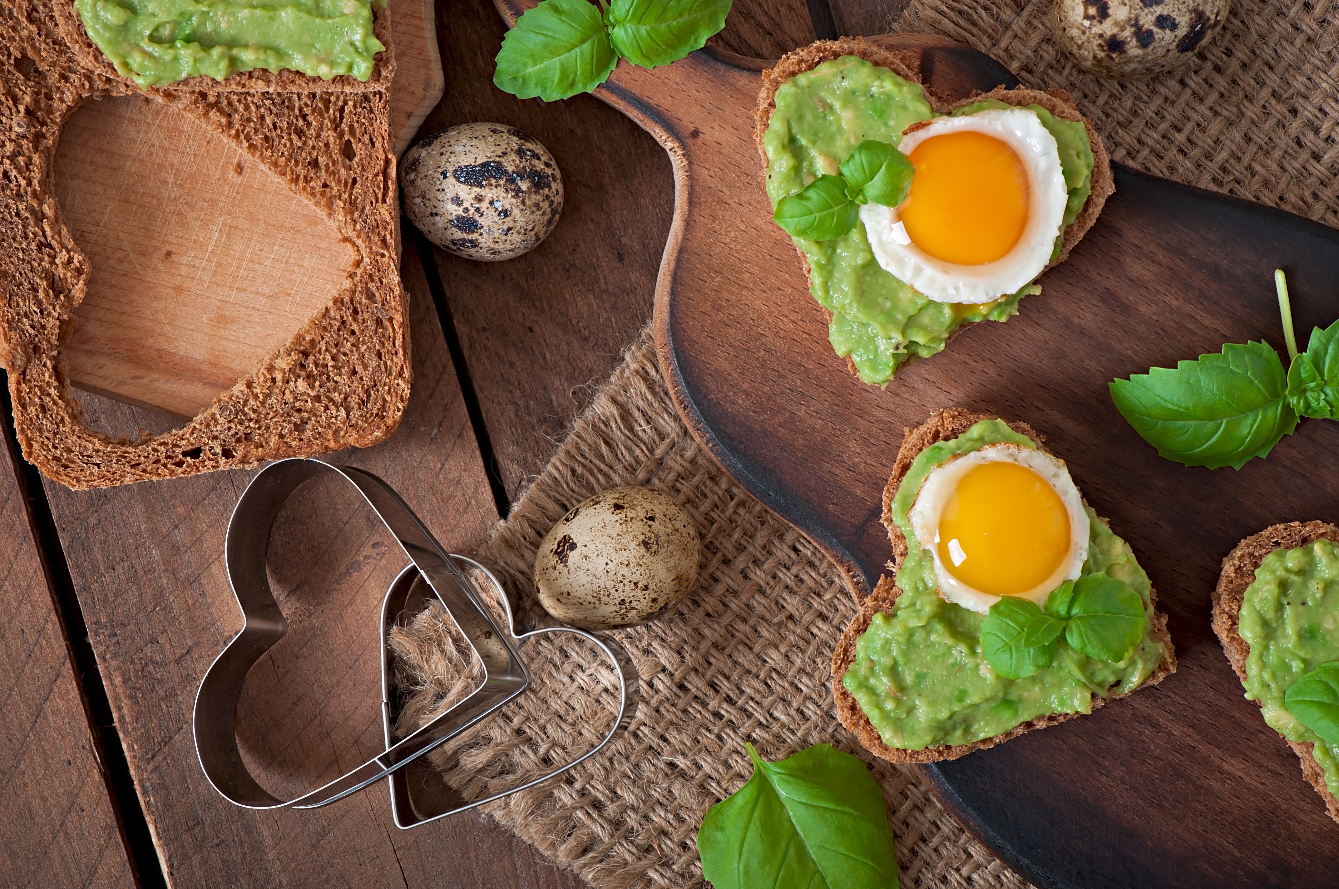 Heart-shaped avocado toast with fried quail eggs HD Wallpaper