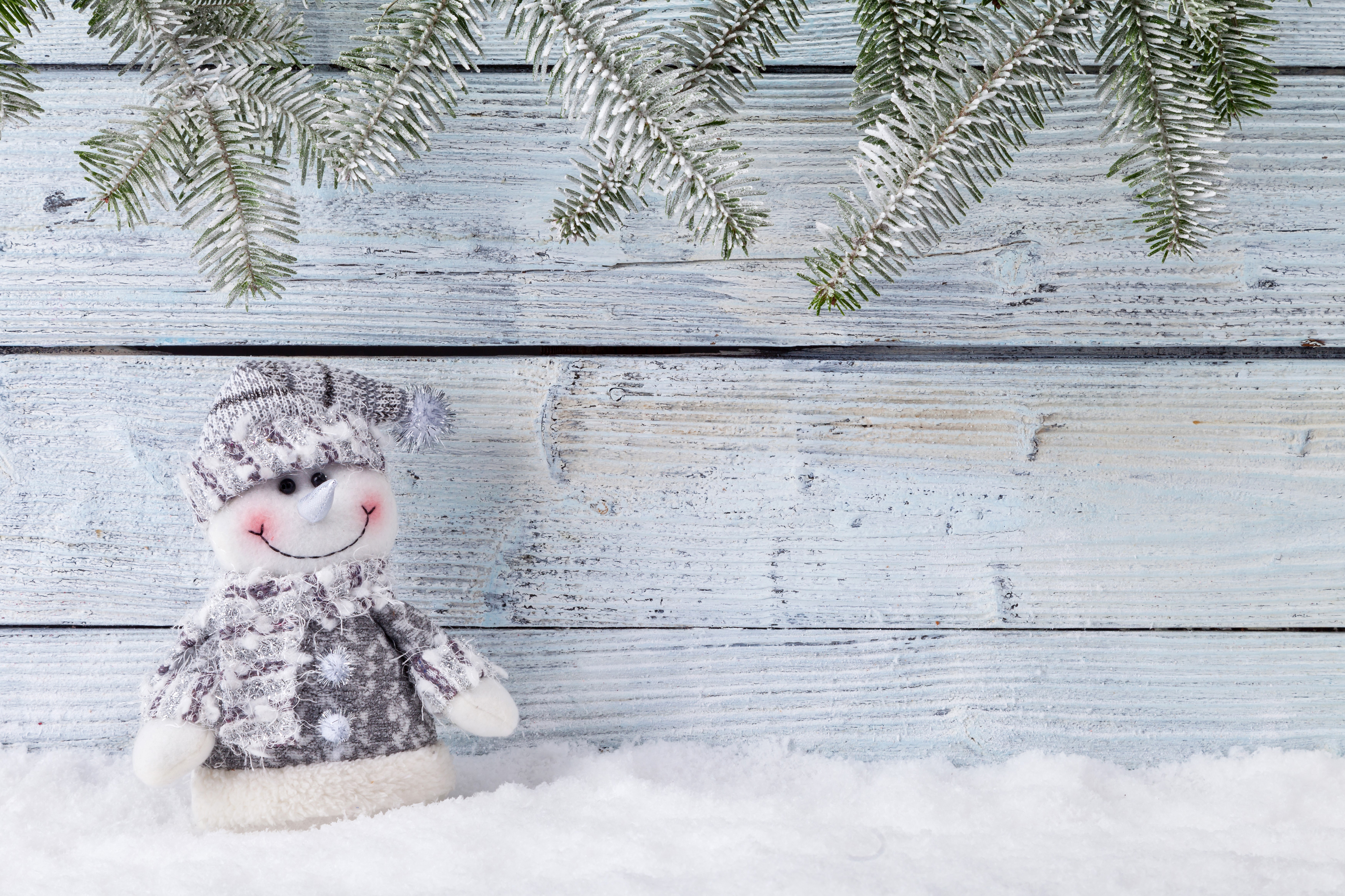 Snowman on wood planks with pine branches HD Wallpaper