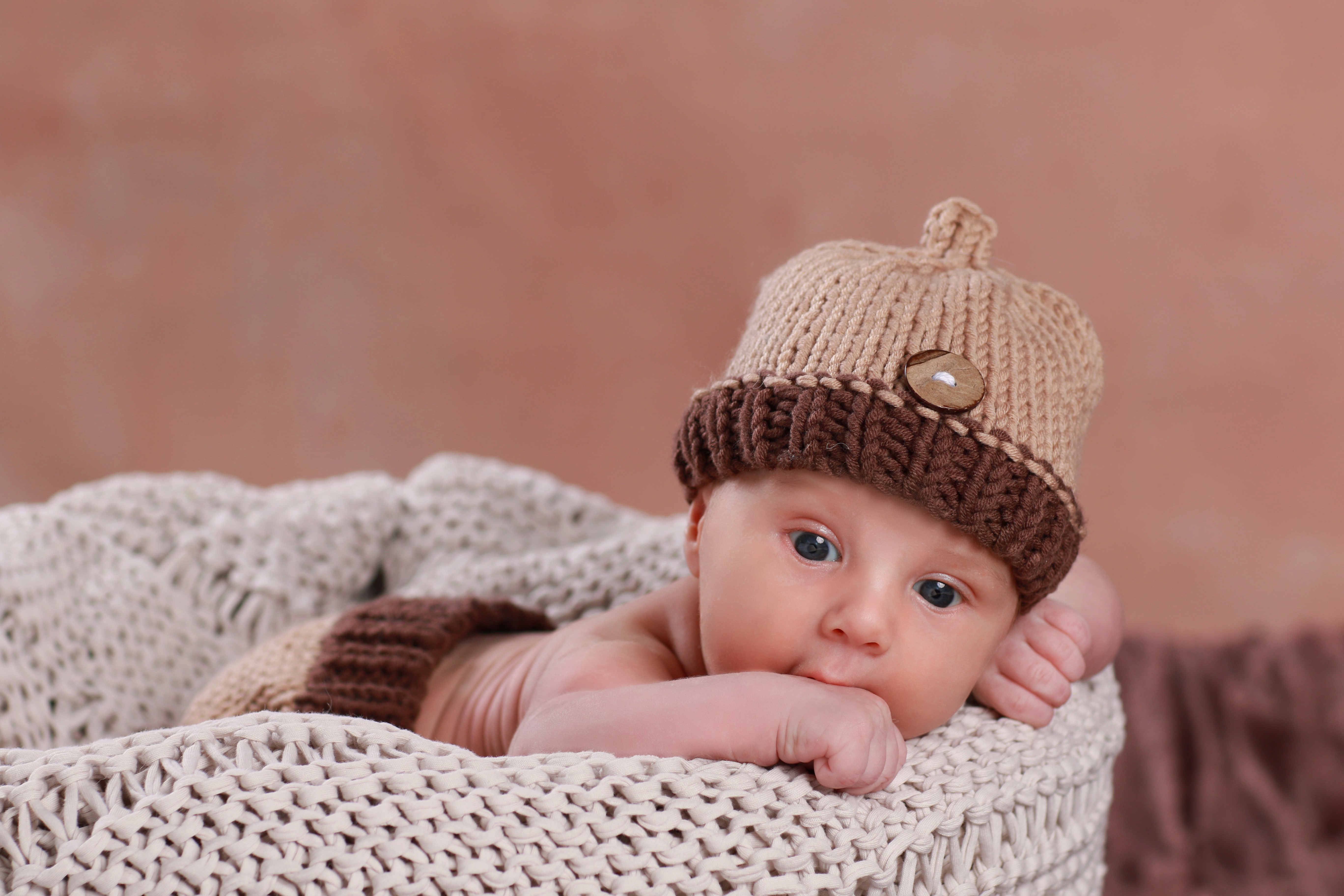 Newborn baby wearing an acorn hat HD Wallpaper