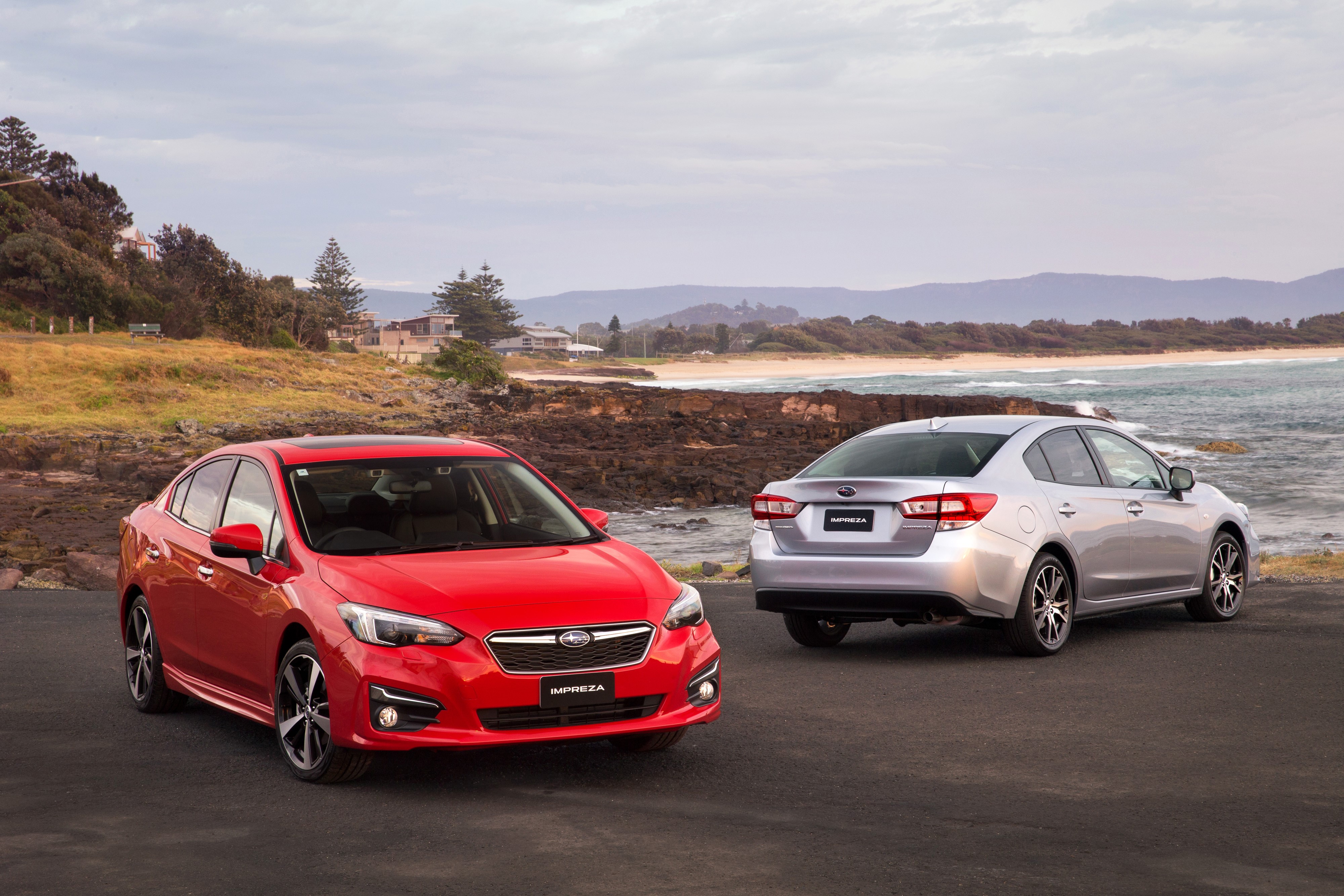 Two Subaru Impreza Sedans by the Ocean HD Wallpaper