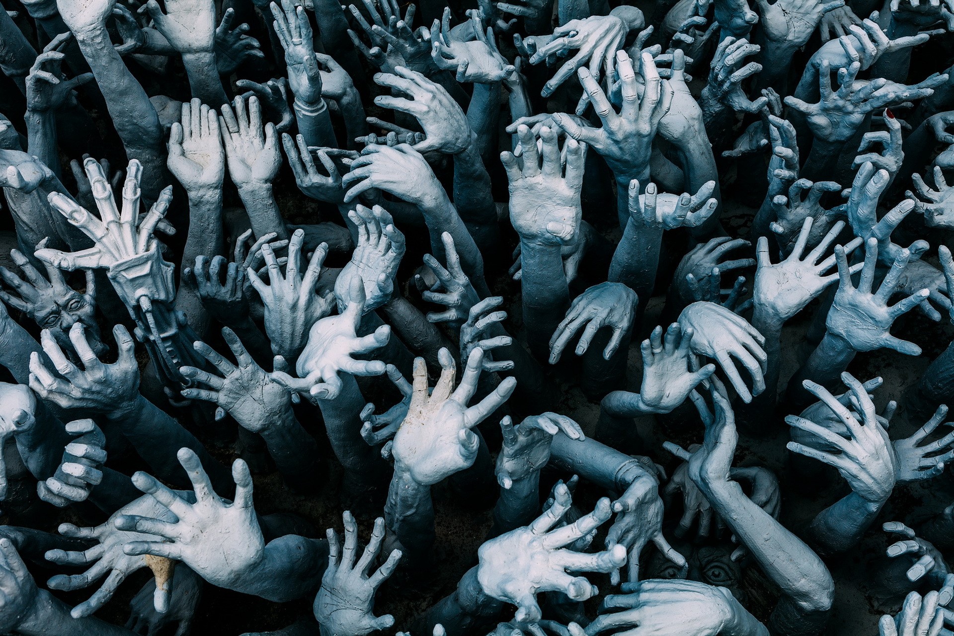 A multitude of pale hands reaching upwards HD Wallpaper
