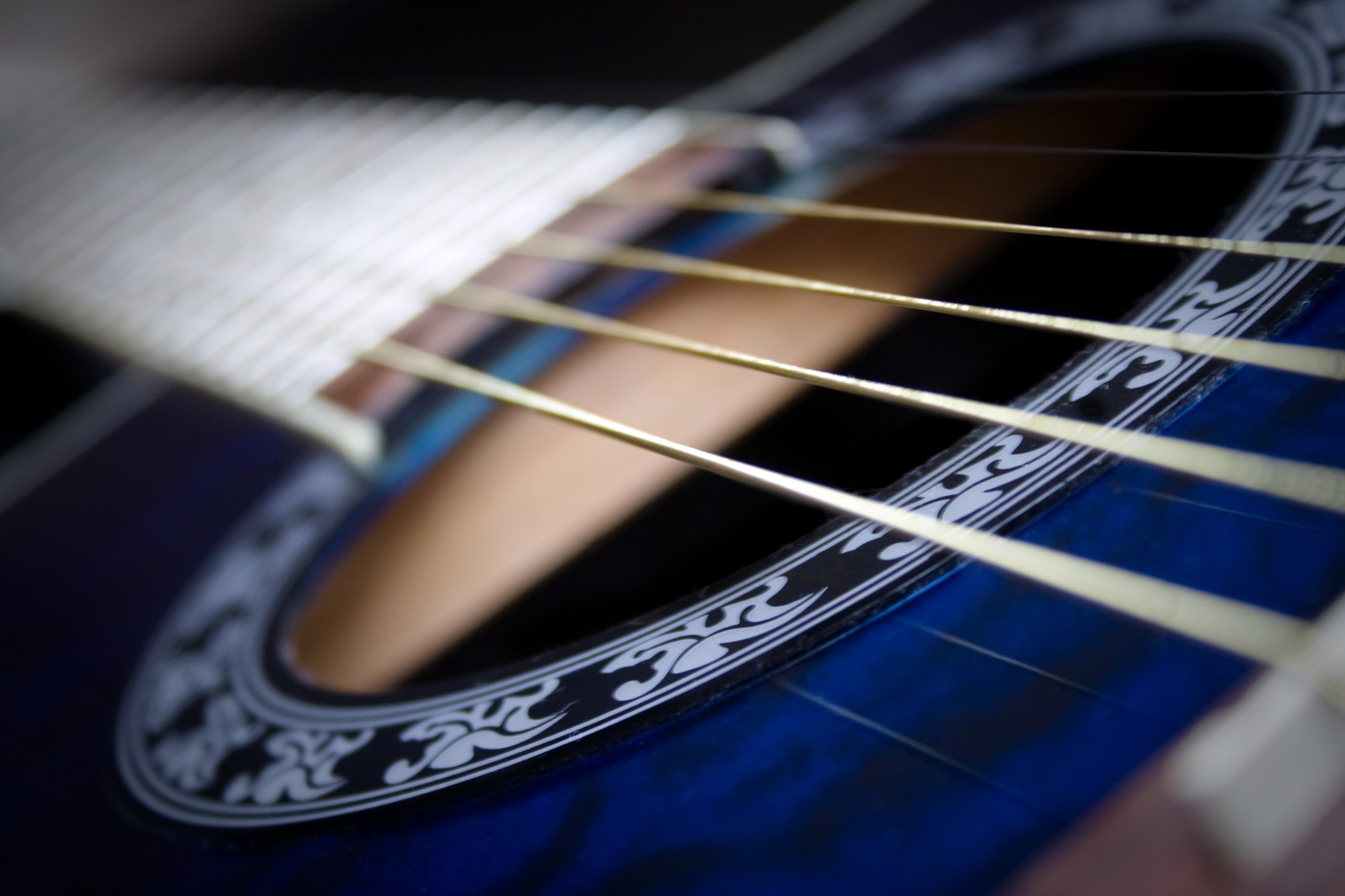 Closeup of acoustic guitar strings and soundhole HD Wallpaper
