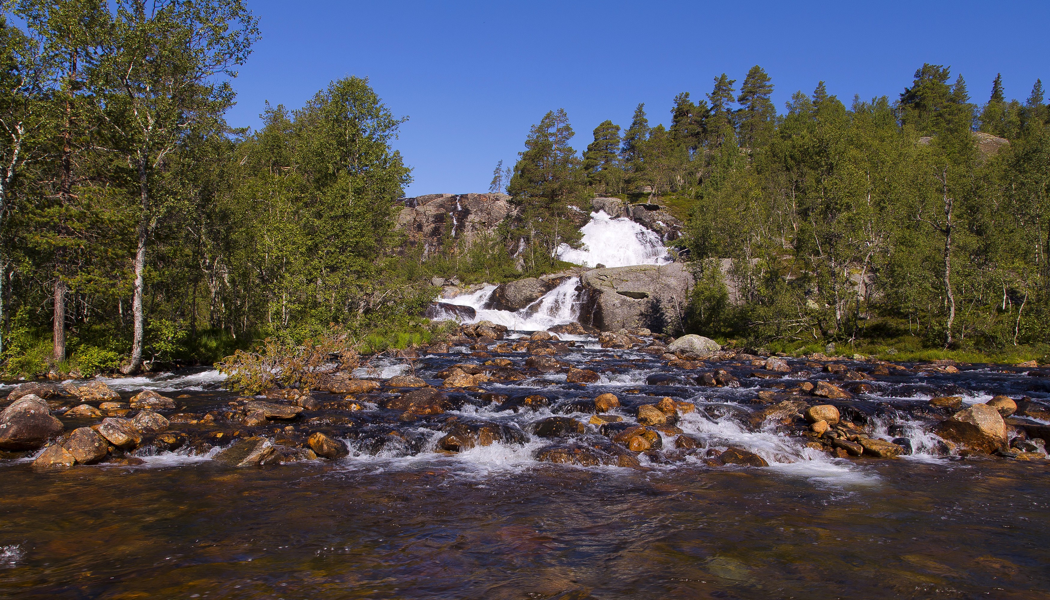 Waterfall cascading over rocks in Norway HD Wallpaper