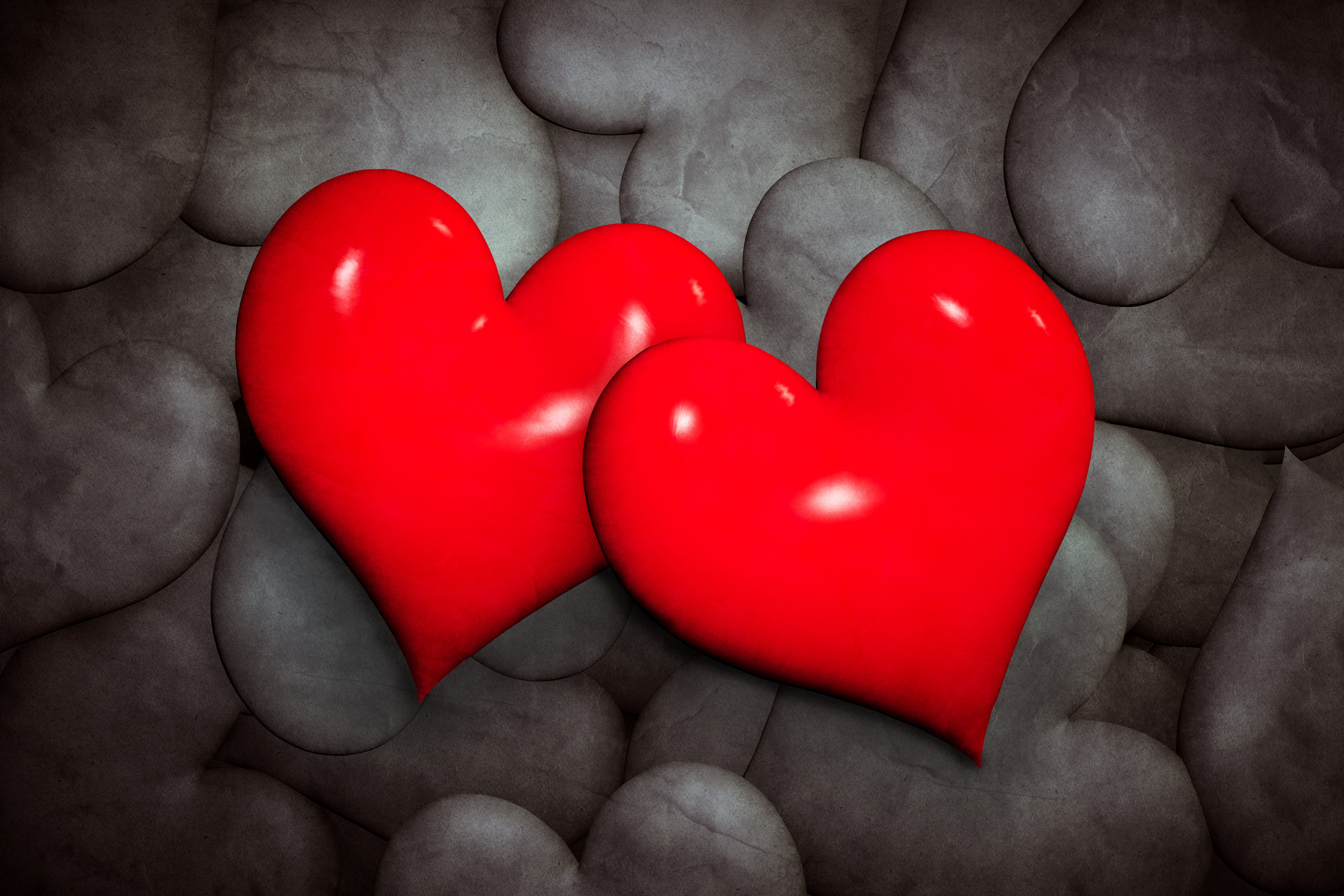 Two red hearts on a background of gray stones HD Wallpaper