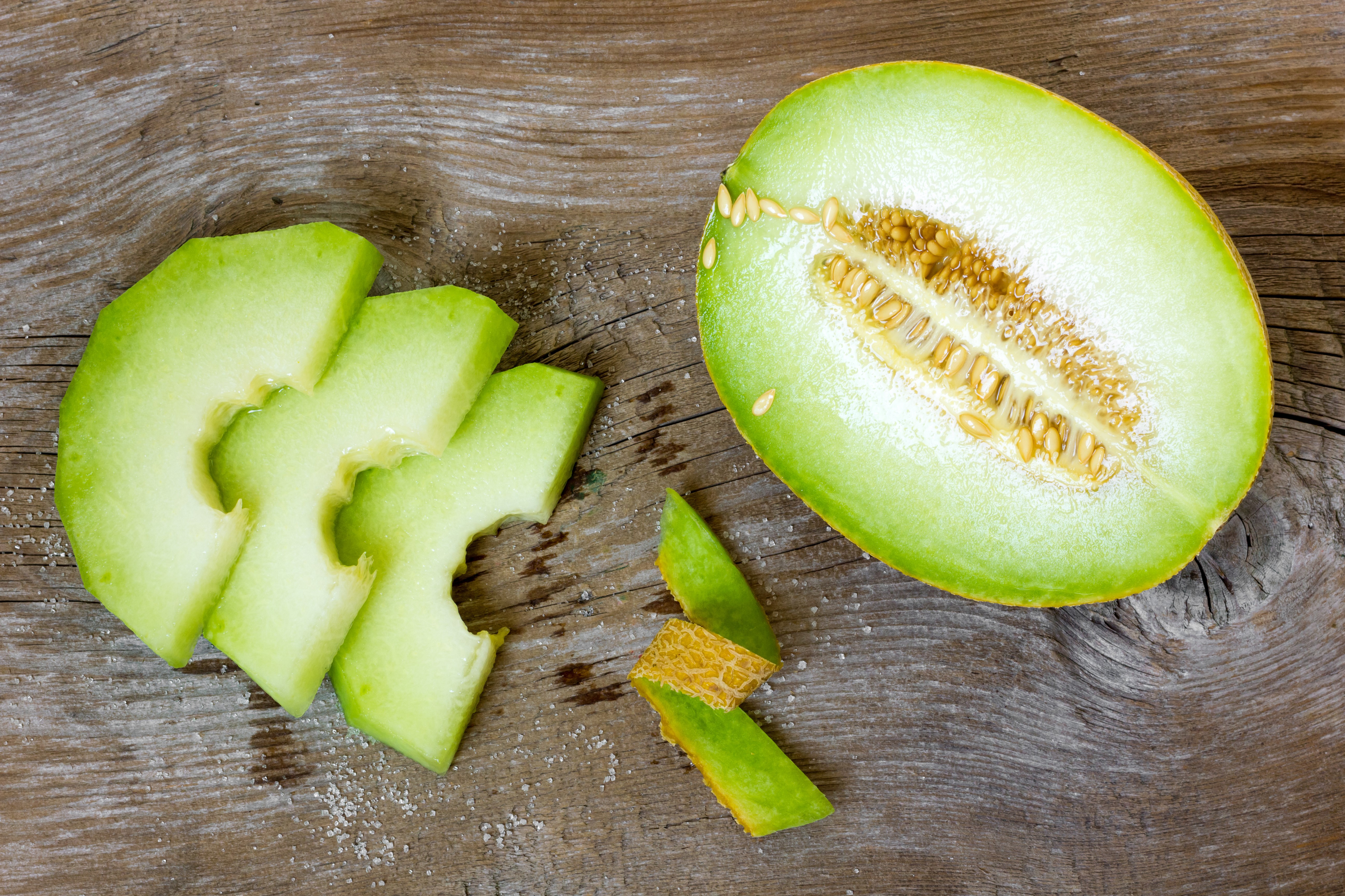 Melon slices and half melon on wood HD Wallpaper
