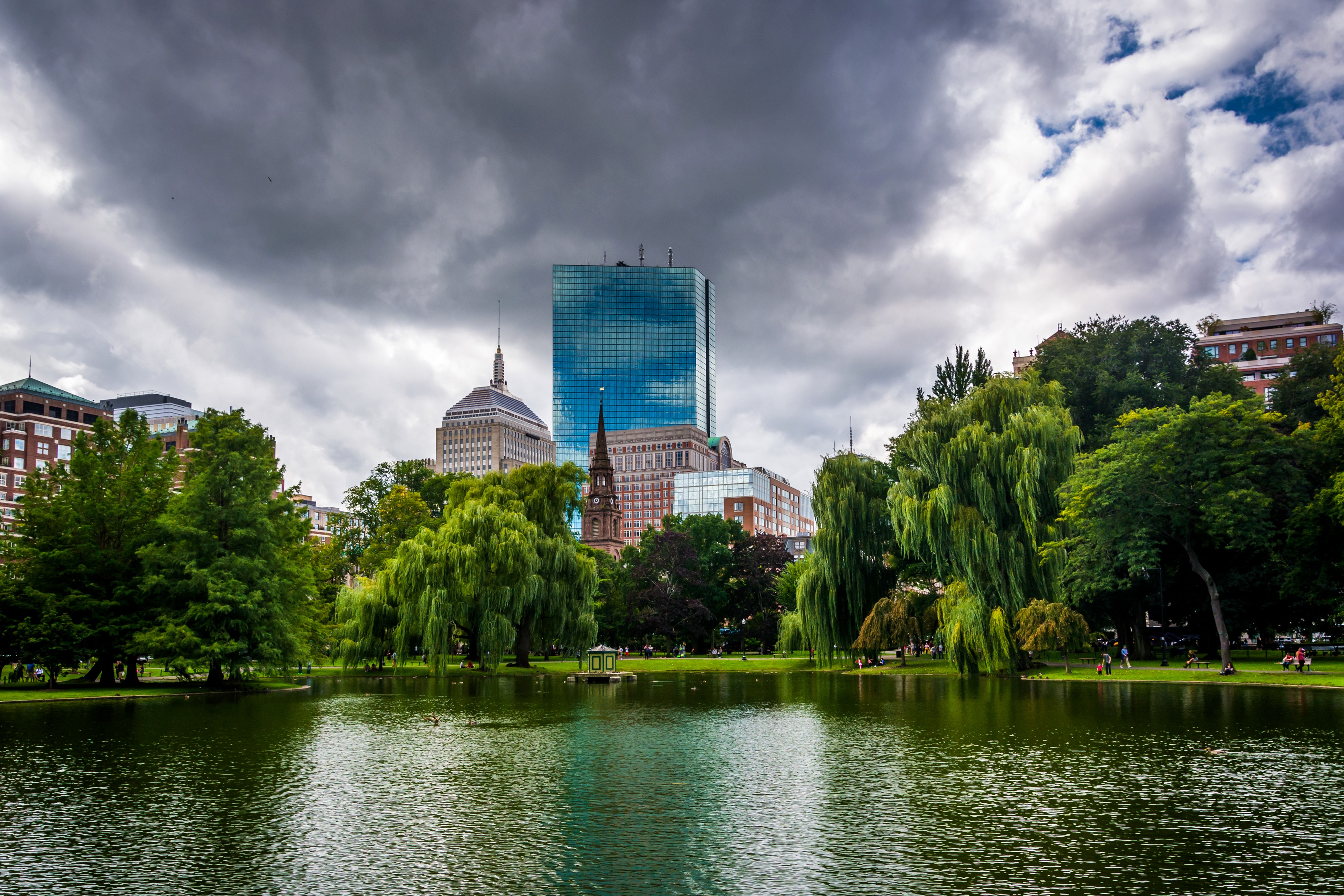 Boston skyline over pond with trees and clouds HD Wallpaper
