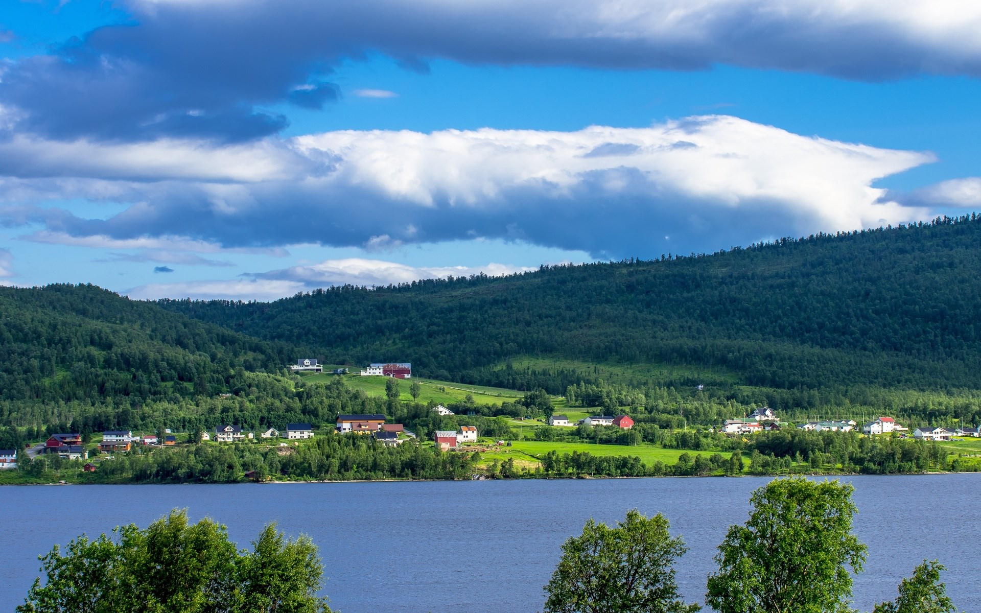 Village on a hill overlooking a lake HD Wallpaper