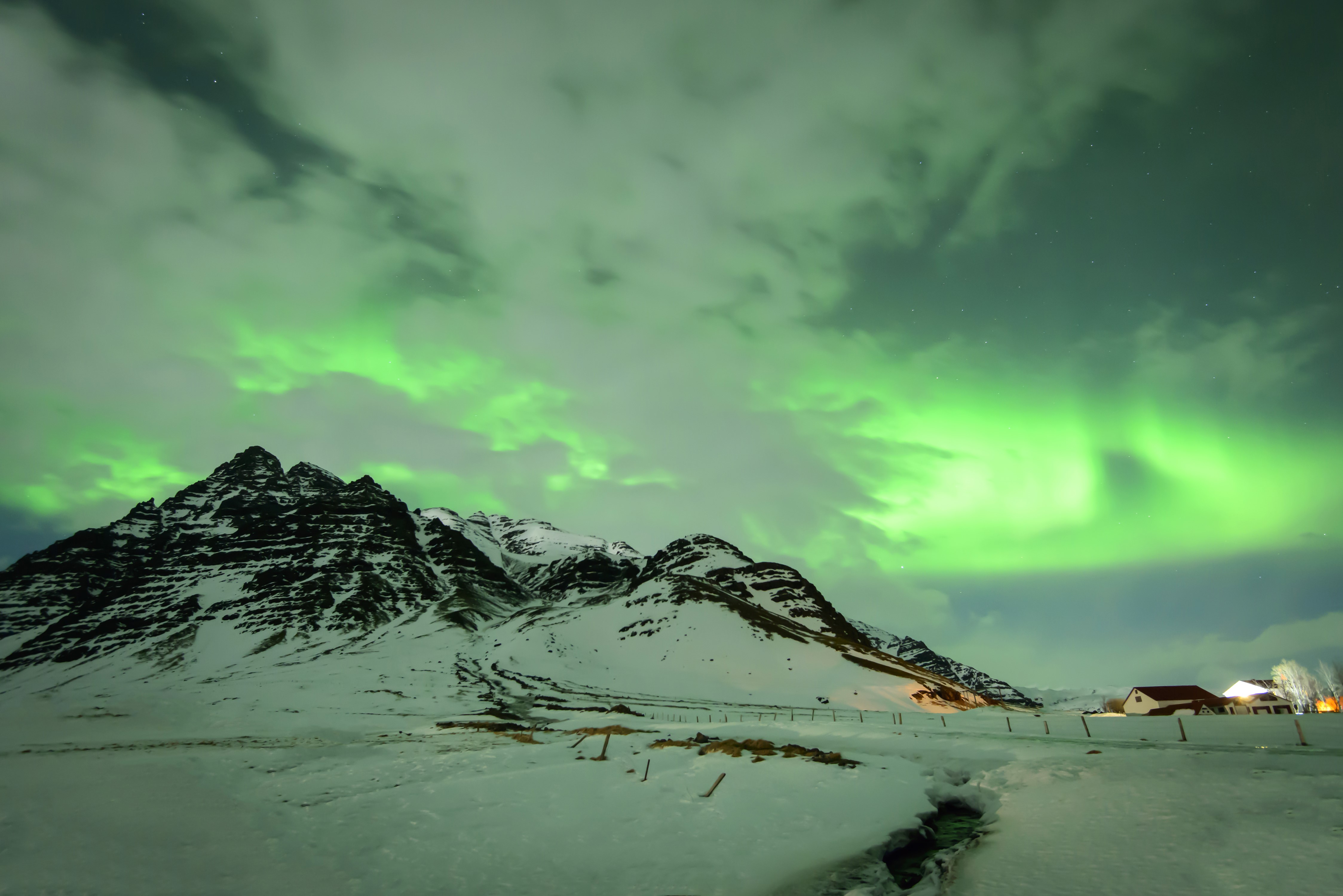 Aurora Borealis over Snowy Mountains in Iceland HD Wallpaper