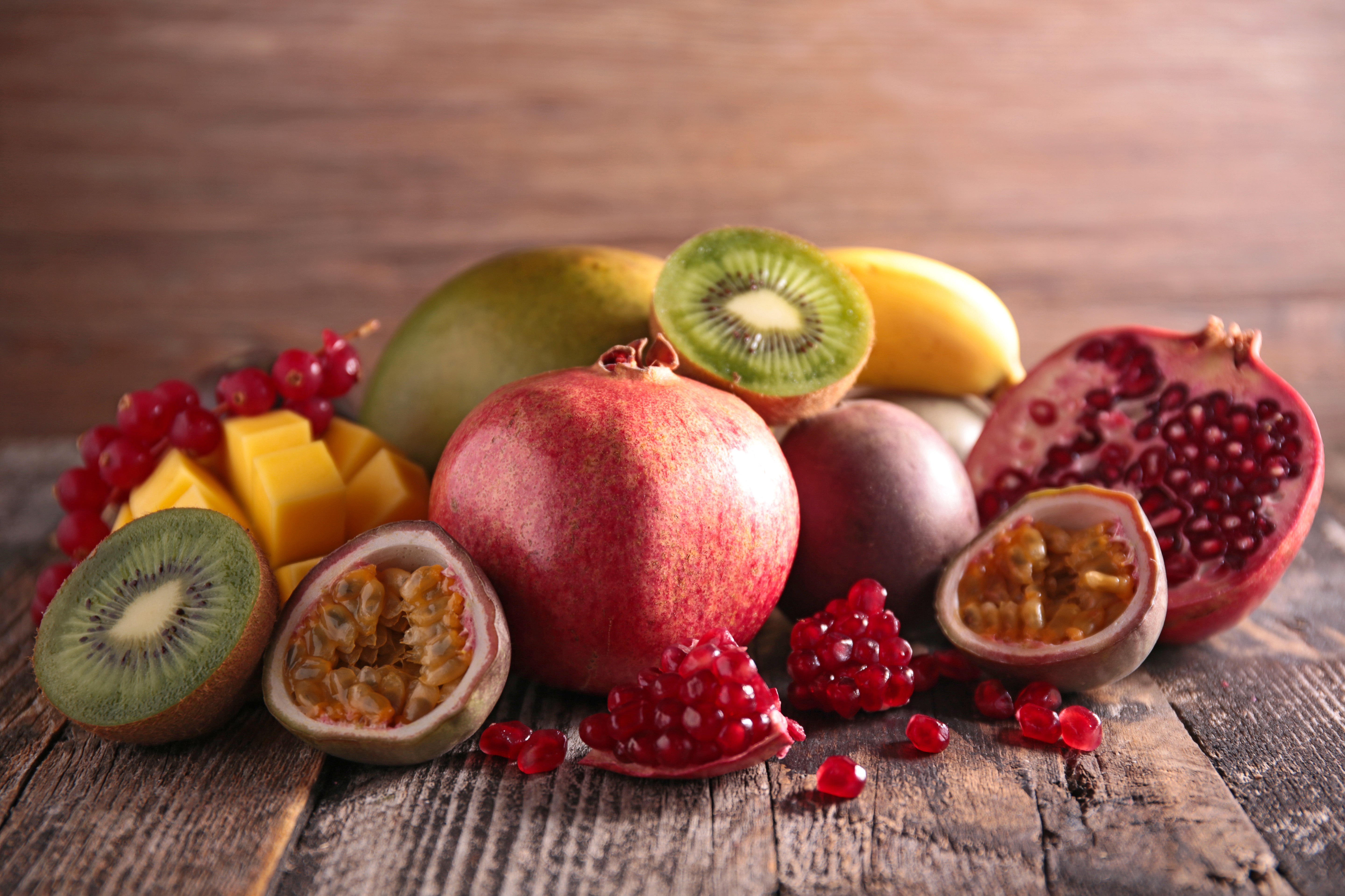Assortment of exotic fruits on wooden planks HD Wallpaper