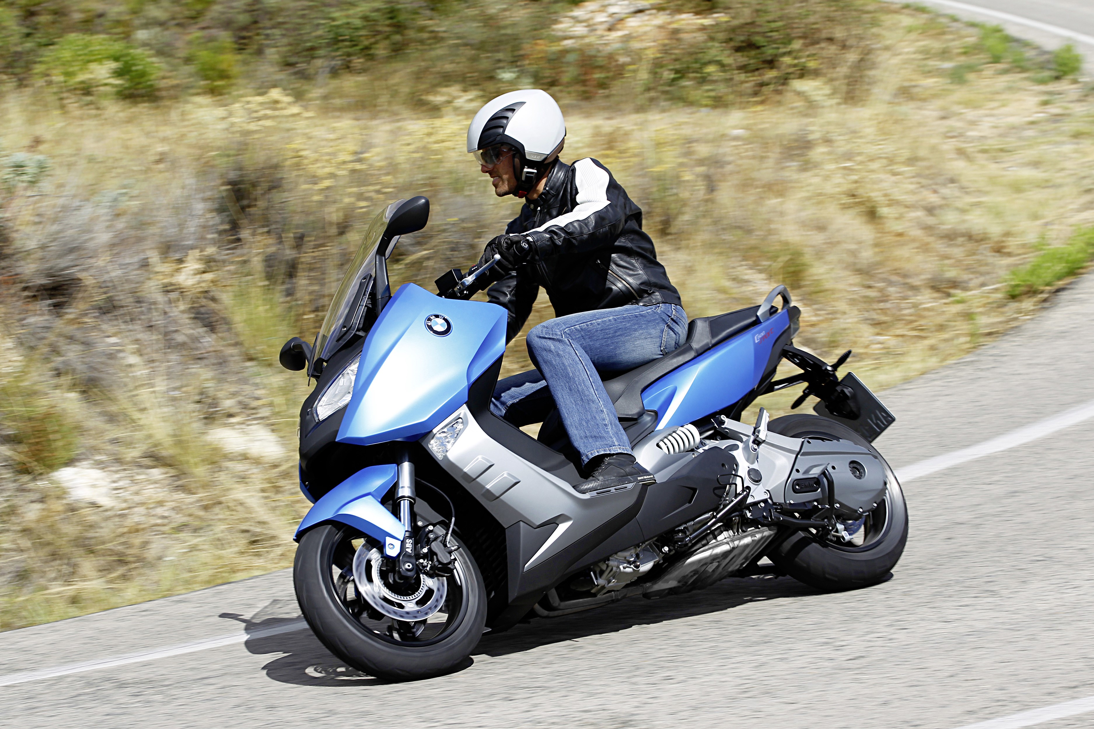 BMW C 600 Sport scooter with rider on a road HD Wallpaper