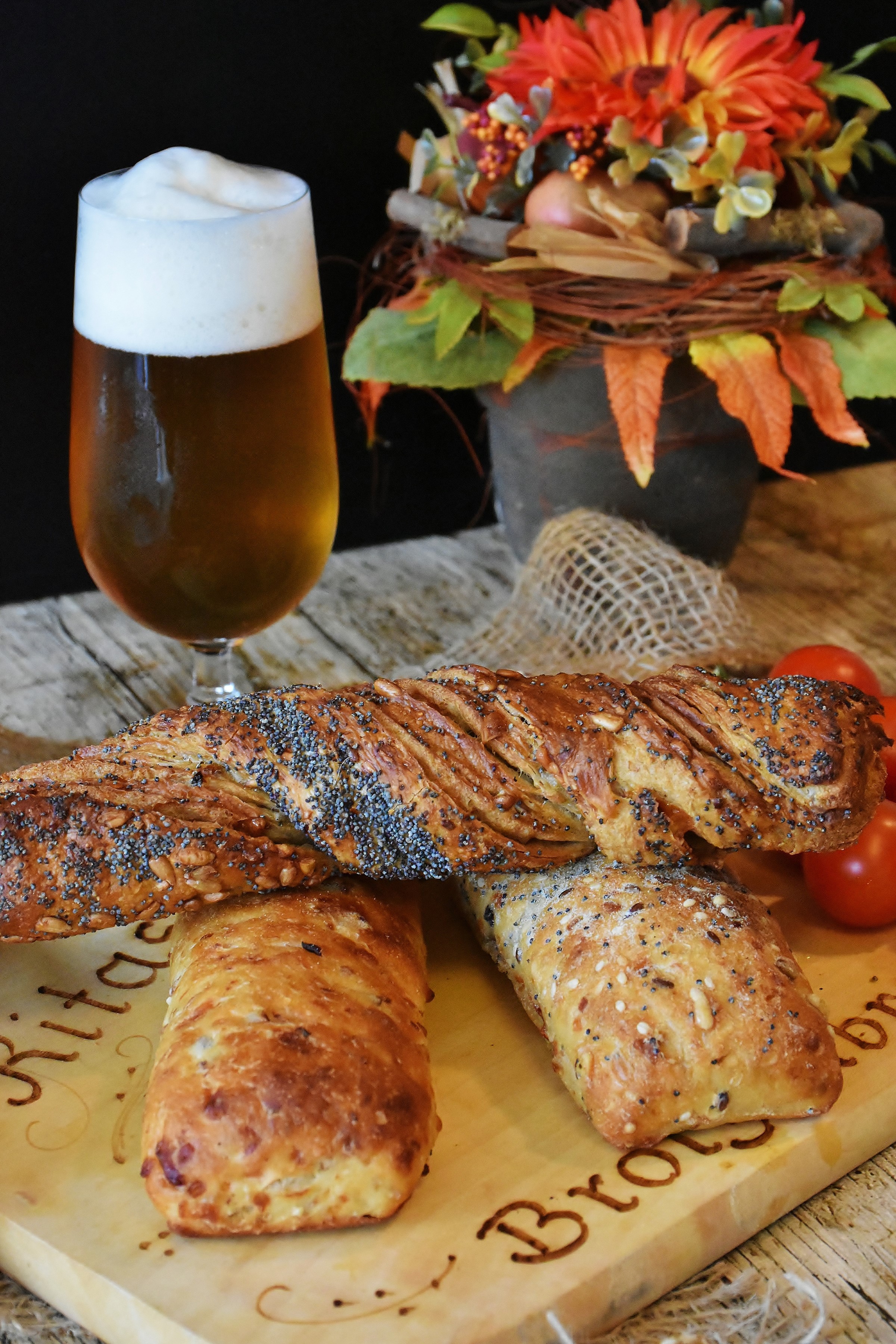 Beer with breadsticks and tomatoes on a wooden board HD Phone Wallpaper