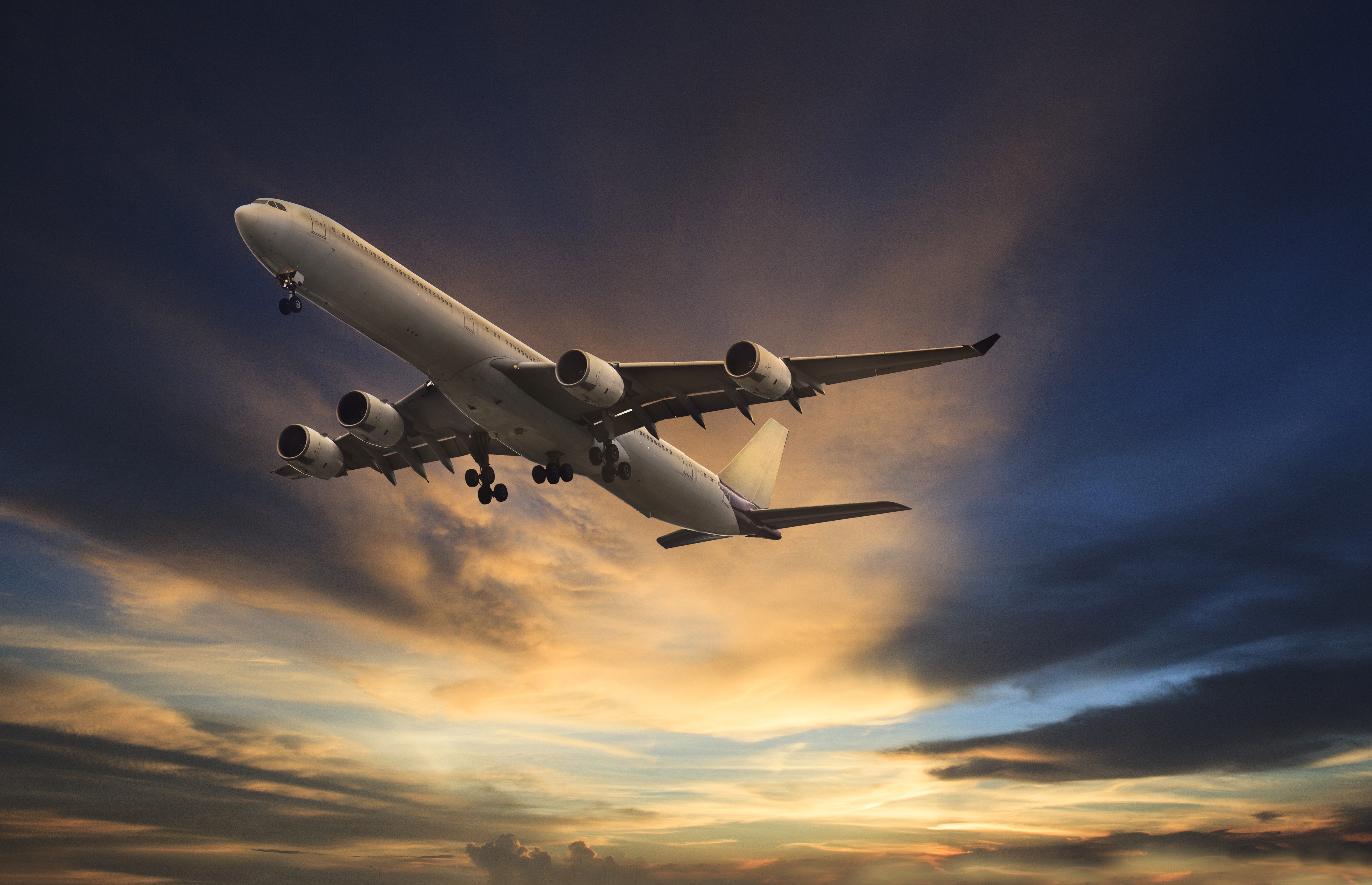 Airplane flying in the sky at sunset HD Wallpaper