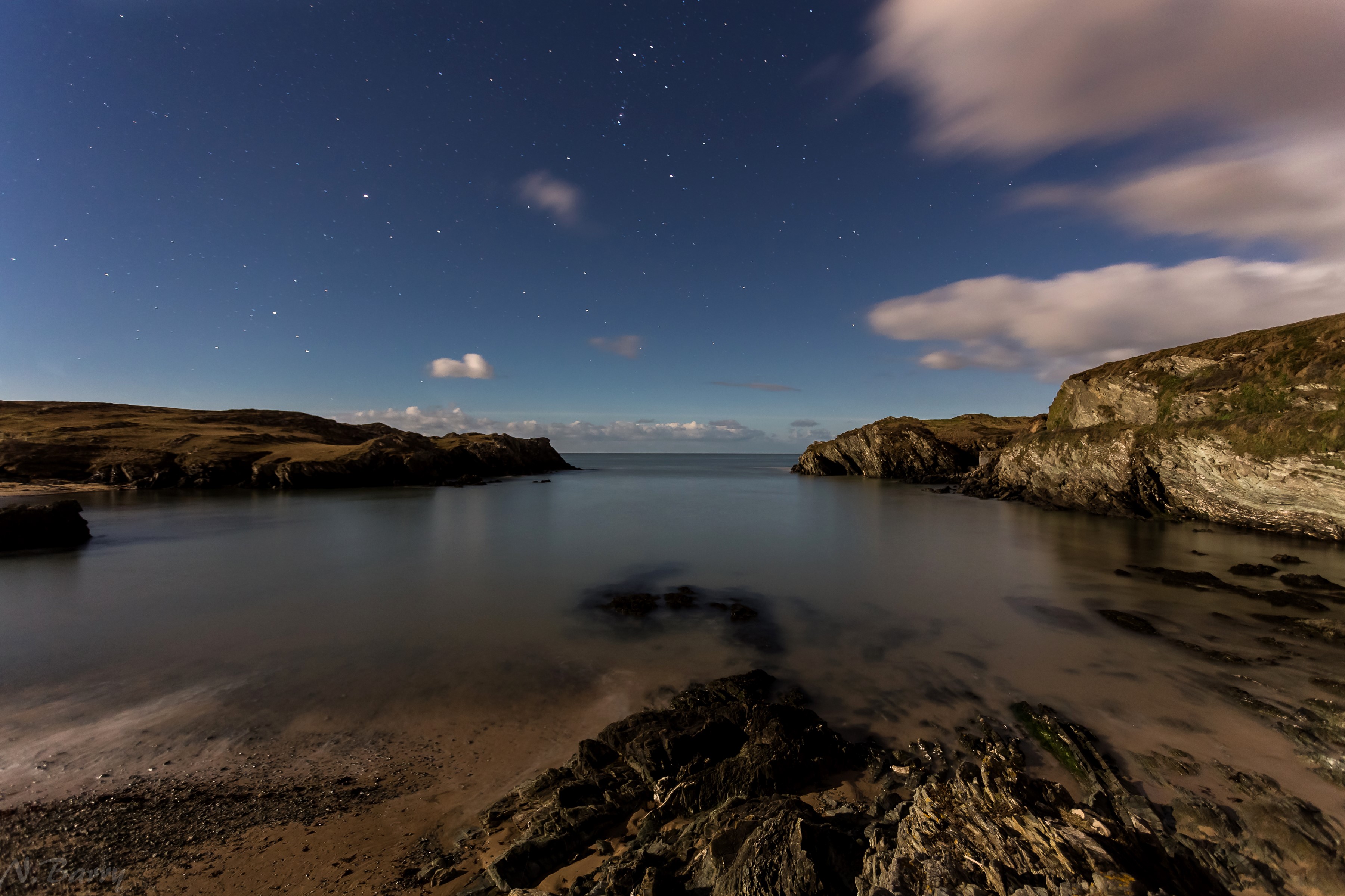 Porth Dafarch coast at night under a starry sky HD Wallpaper