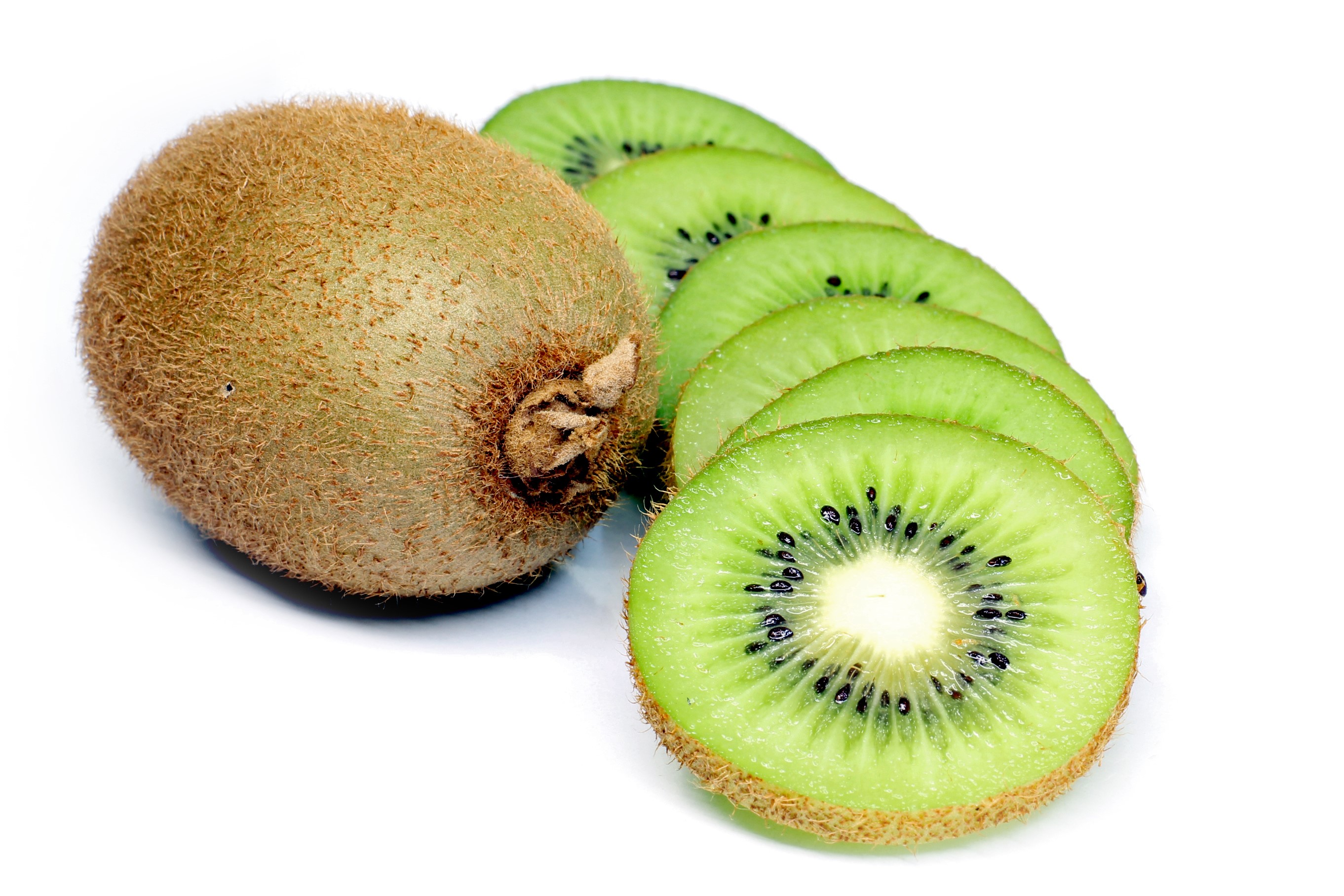 Whole and sliced kiwi fruit on a white background HD Wallpaper
