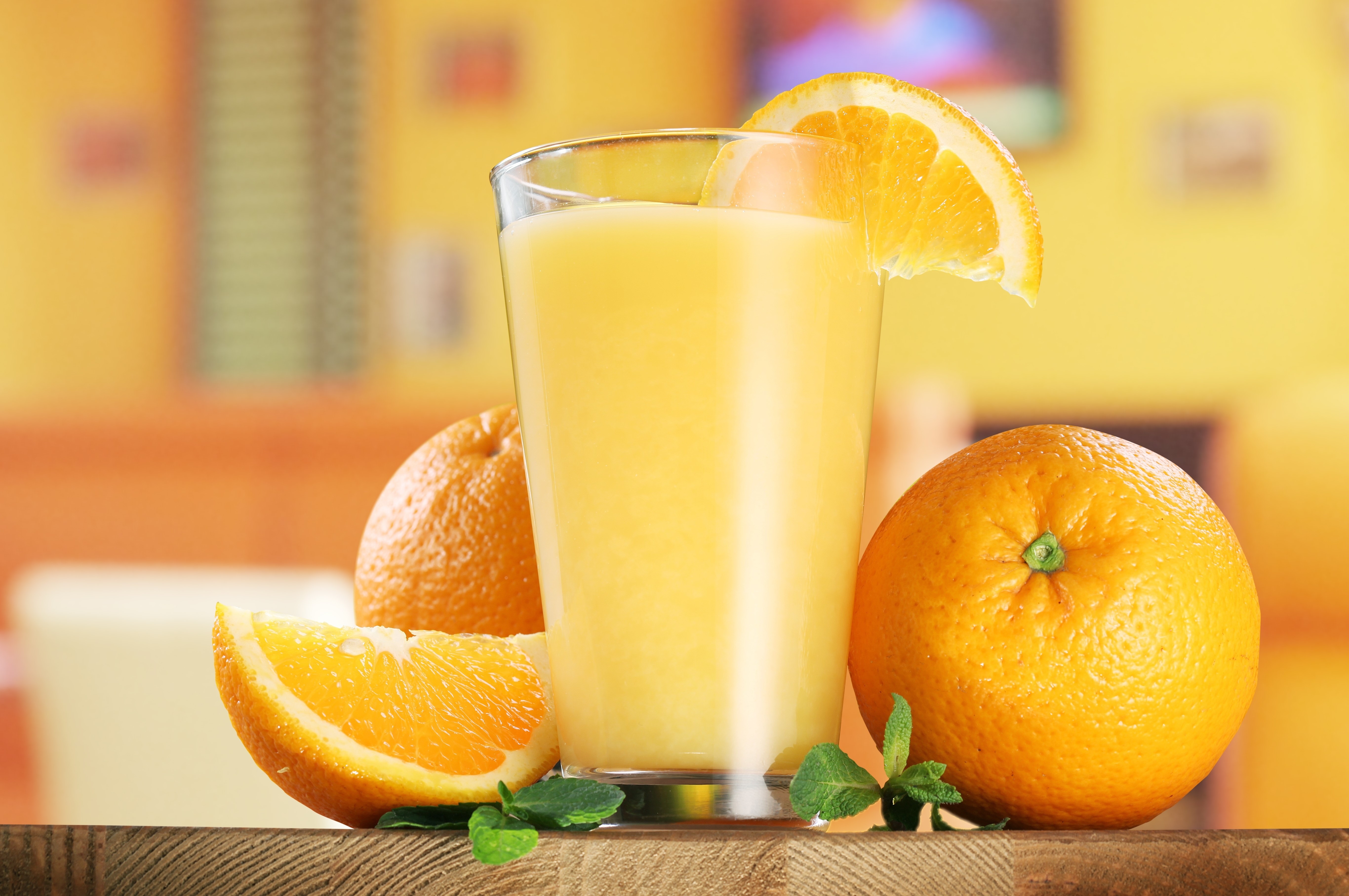 Orange juice in a highball glass with oranges HD Wallpaper