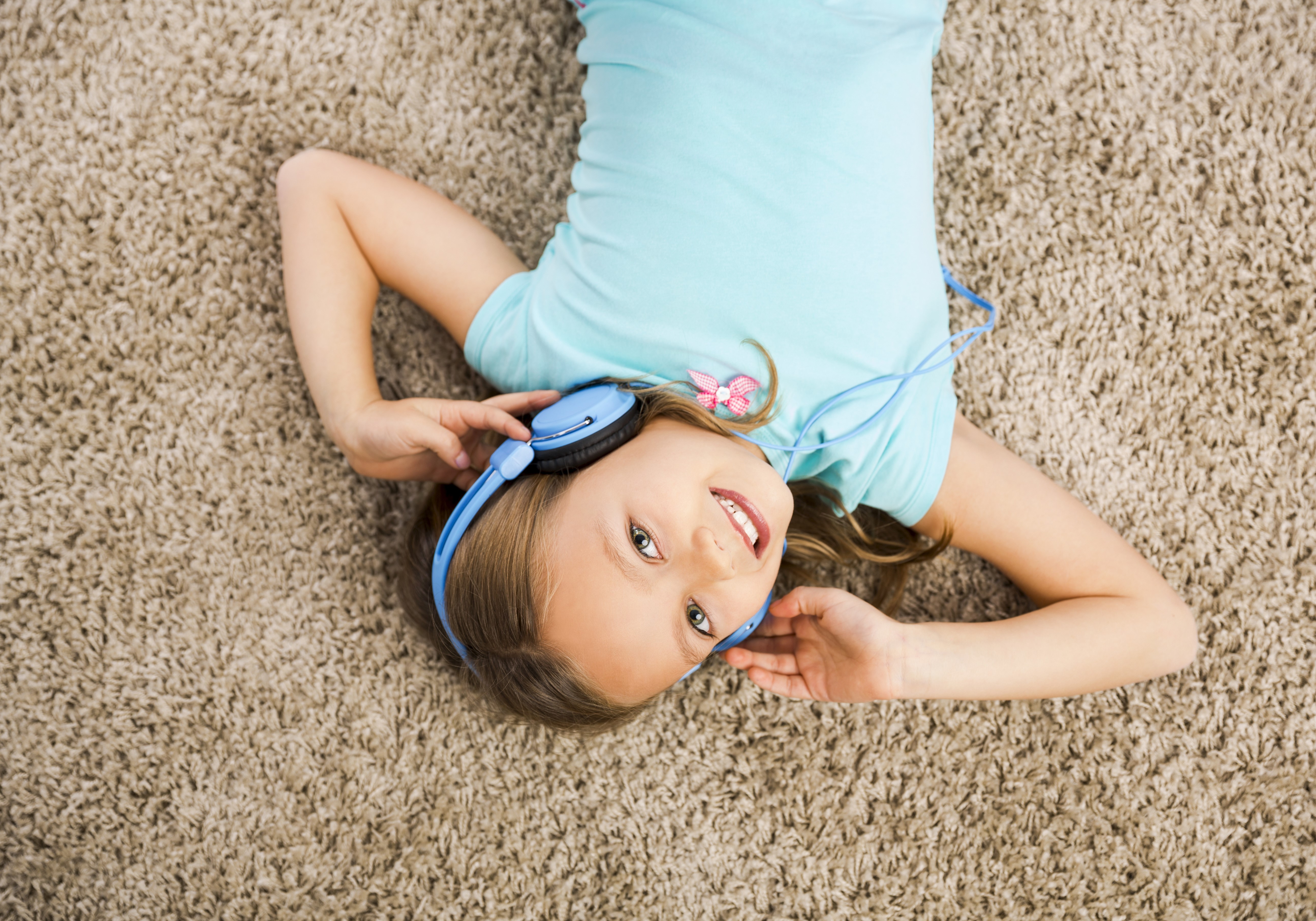 Girl with Headphones Lying on Carpet HD Wallpaper