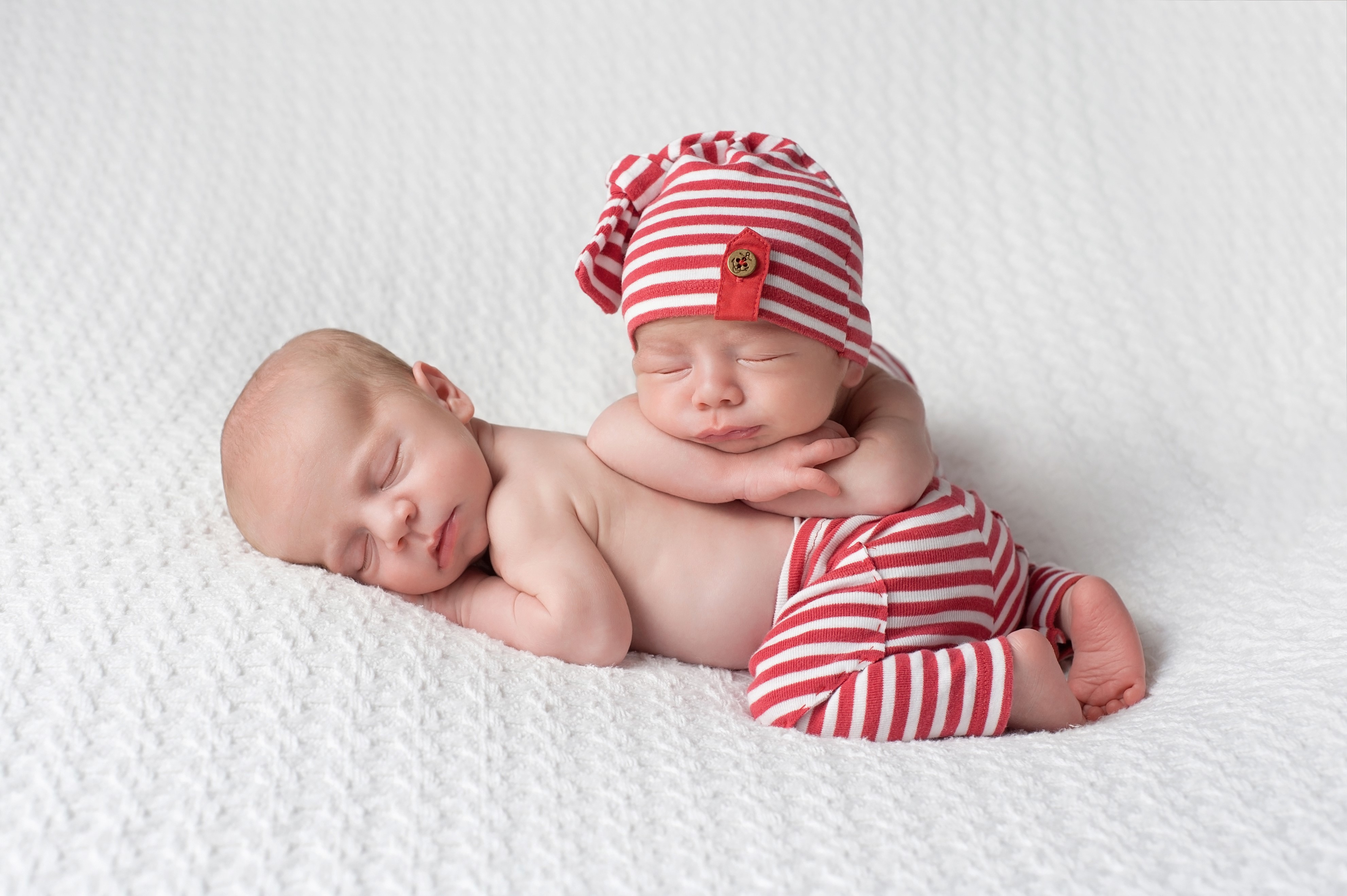 Two Newborn Babies Sleeping in Red and White Striped Outfits HD Wallpaper