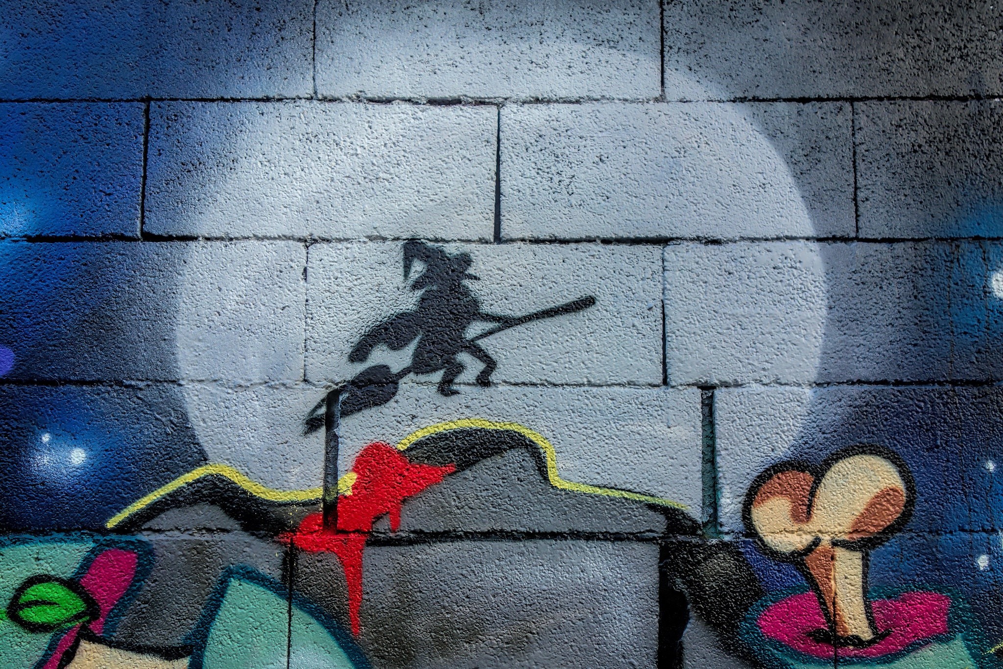 Graffiti of a witch on a broomstick in front of a moon HD Wallpaper