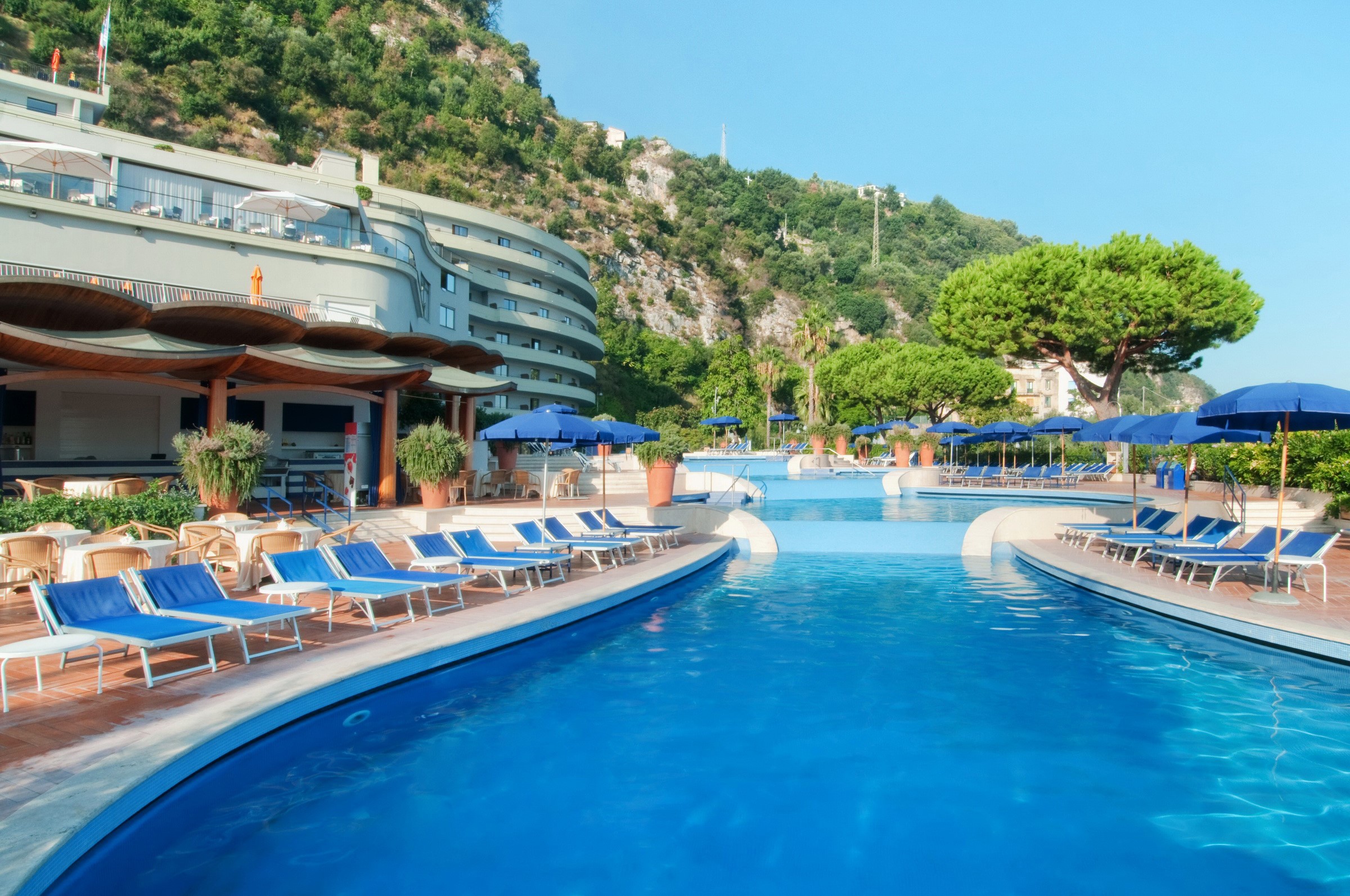 Resort swimming pool with sunloungers and umbrellas in Sorrento, Italy HD Wallpaper