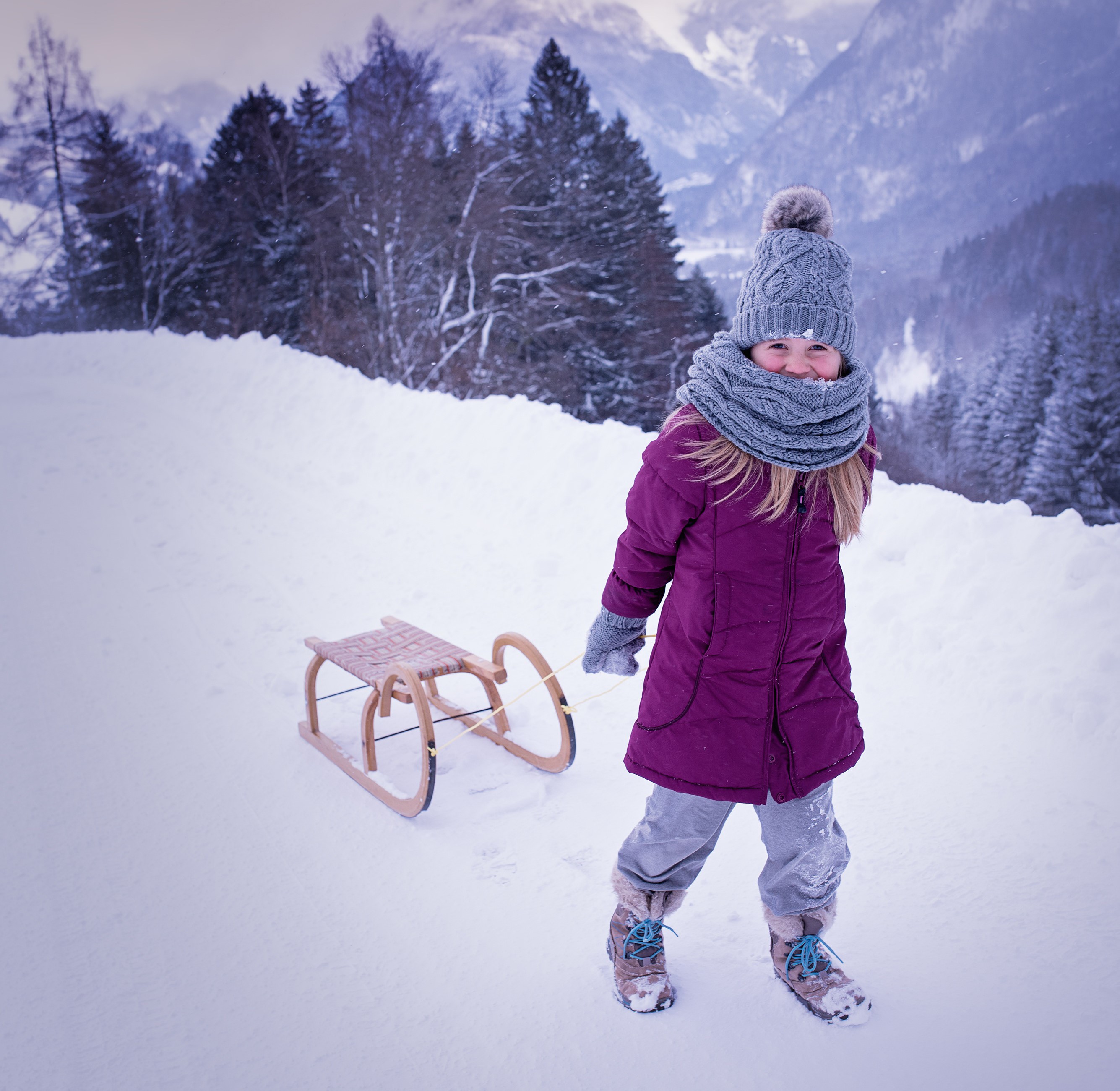 Girl pulling a sled in the snow HD Wallpaper