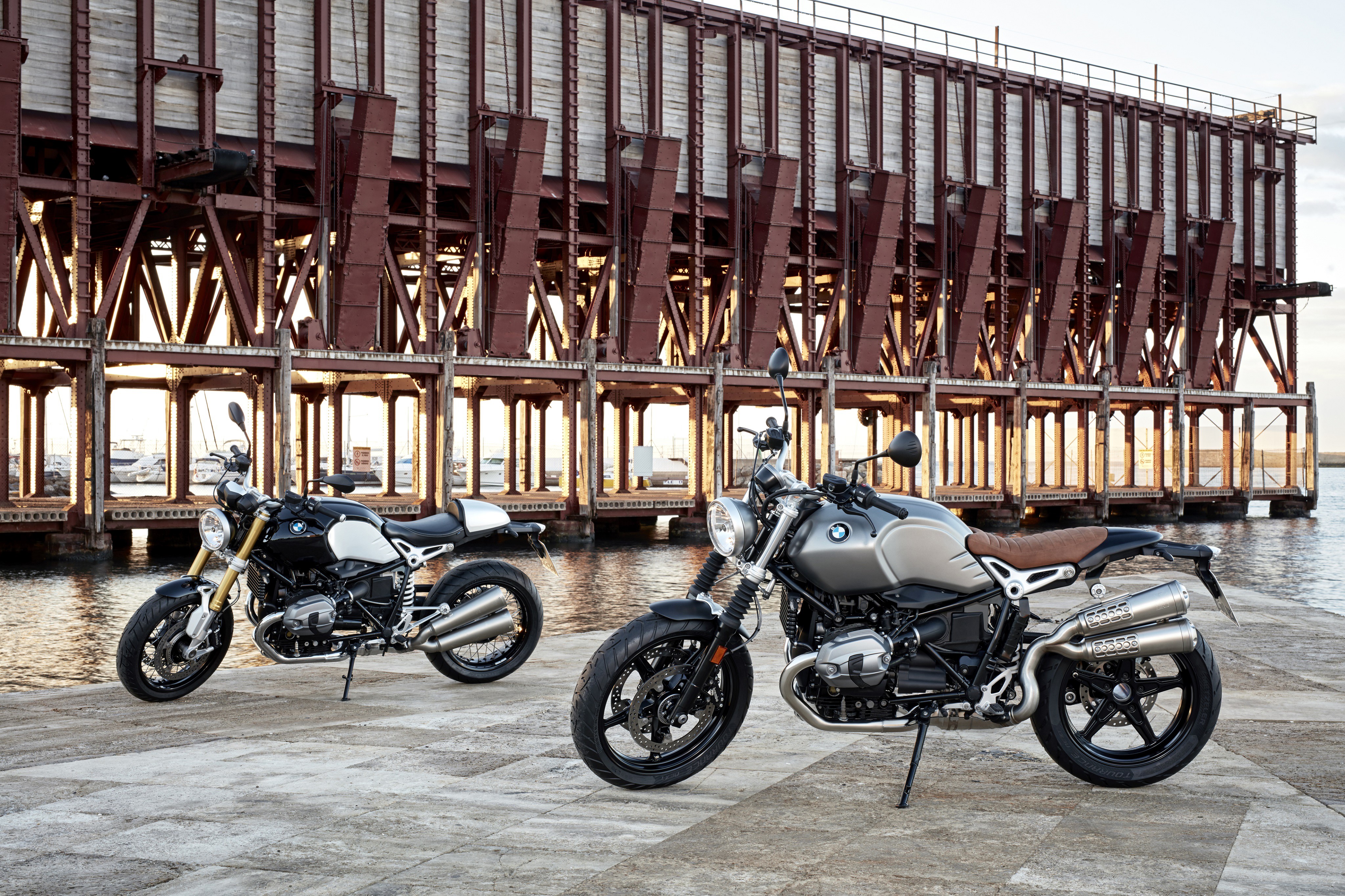 Two BMW R nine T motorcycles by a pier HD Wallpaper