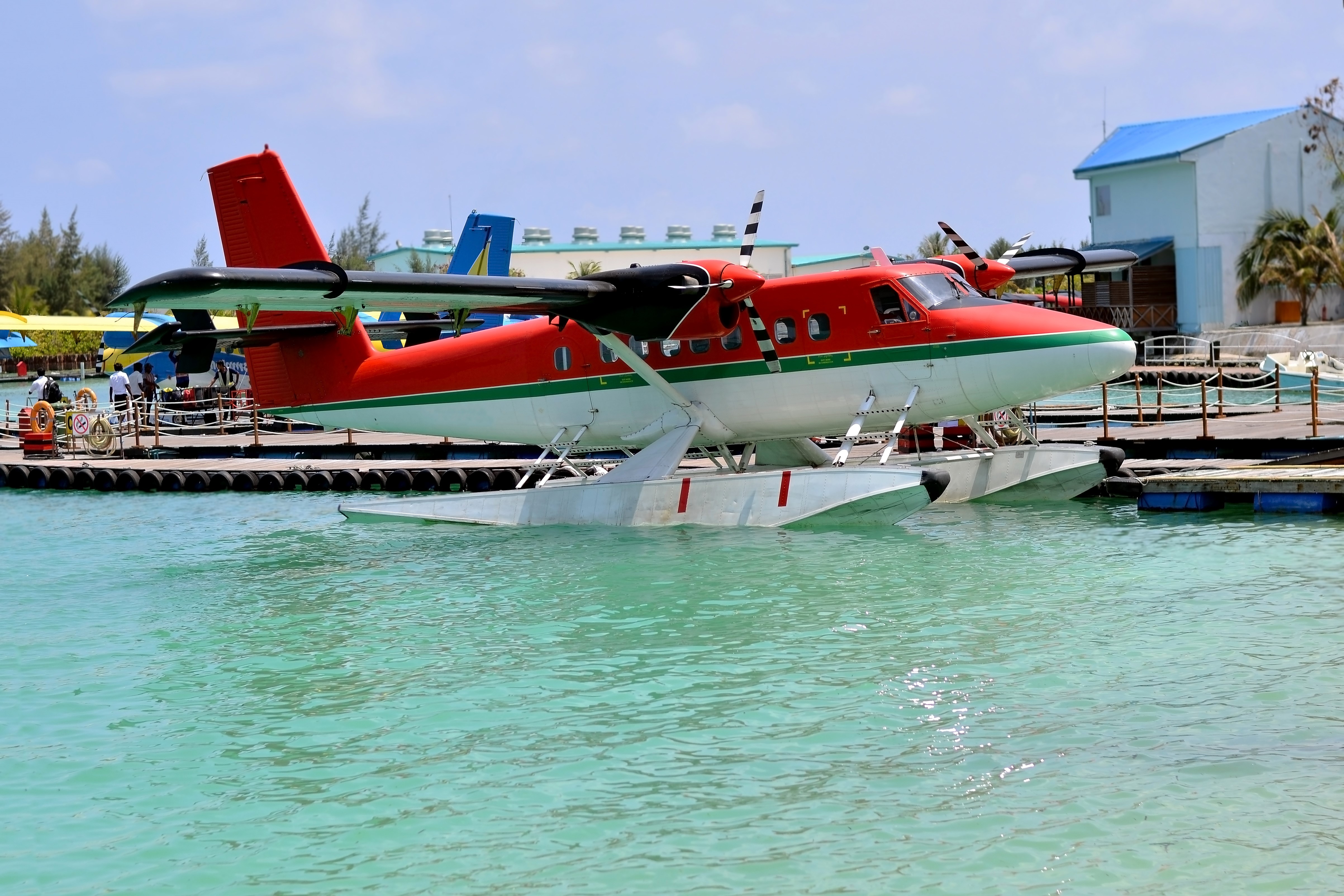 Red and white seaplane at a marina HD Wallpaper