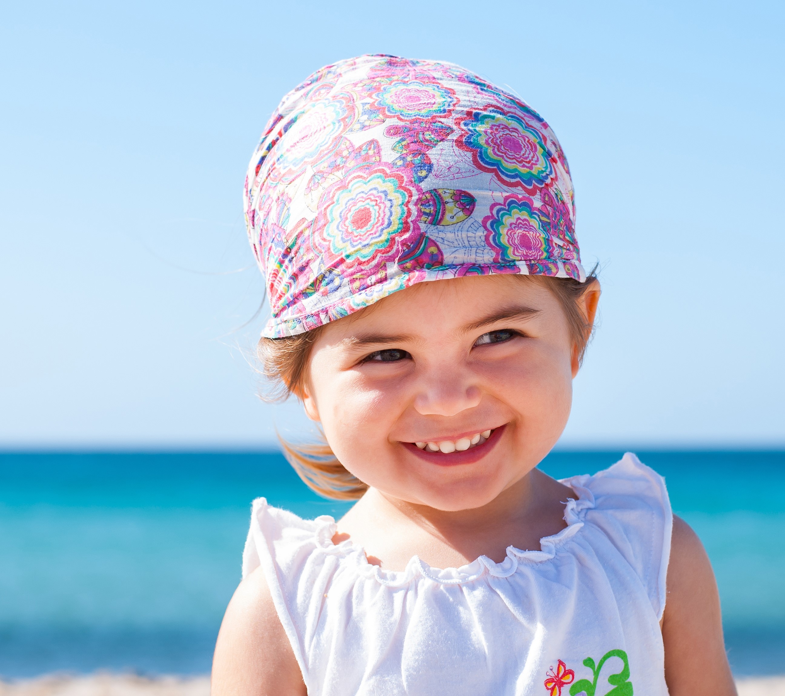 Young girl wearing a bandana on the beach HD Wallpaper