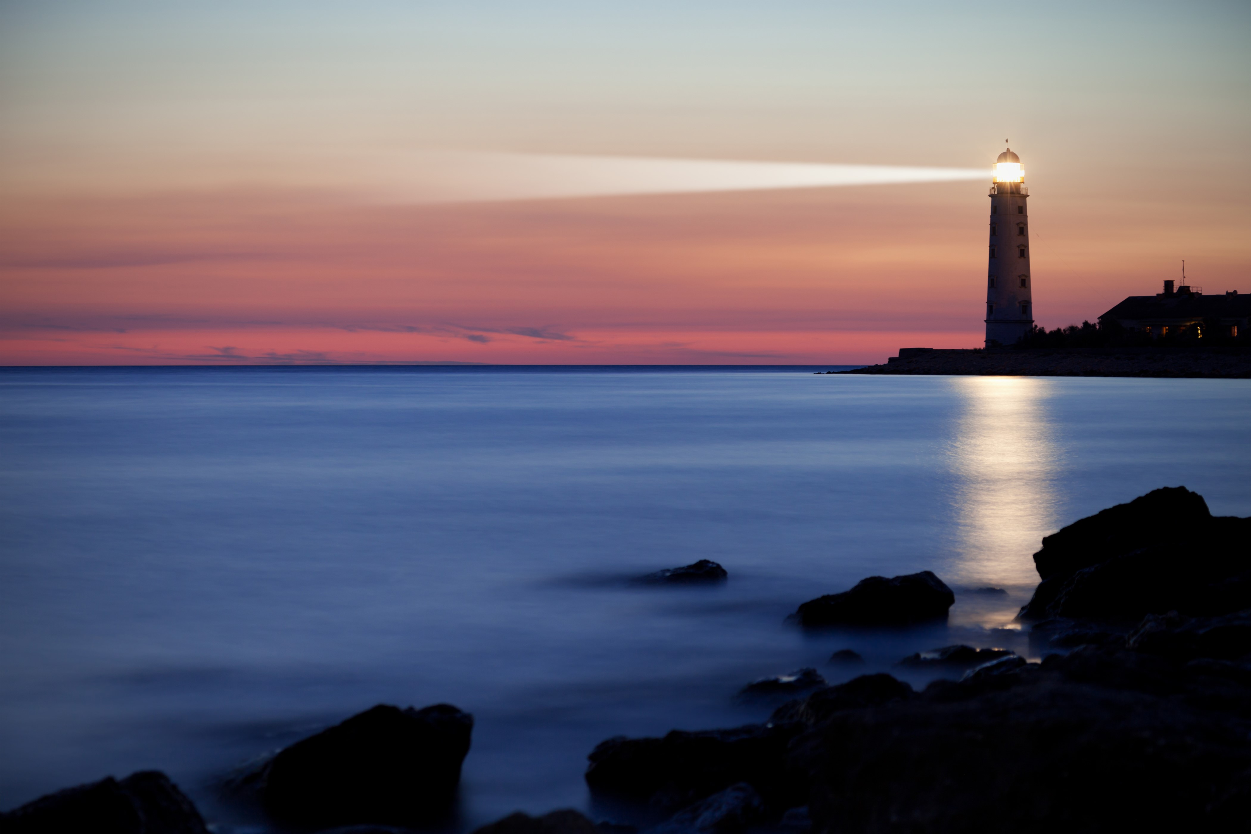 Lighthouse on the coast at dusk HD Wallpaper