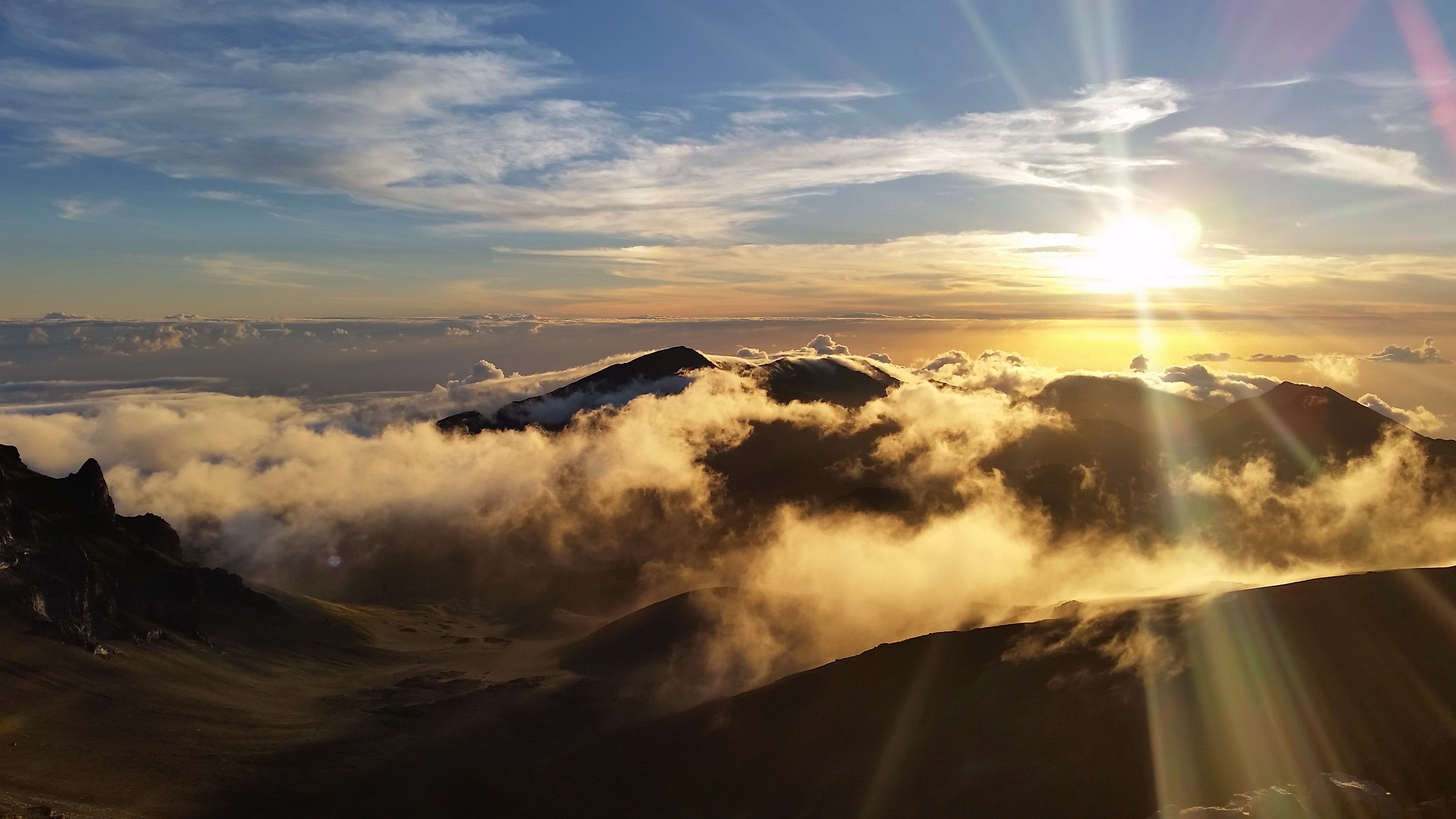 Sunrise over Haleakala National Park with clouds HD Wallpaper
