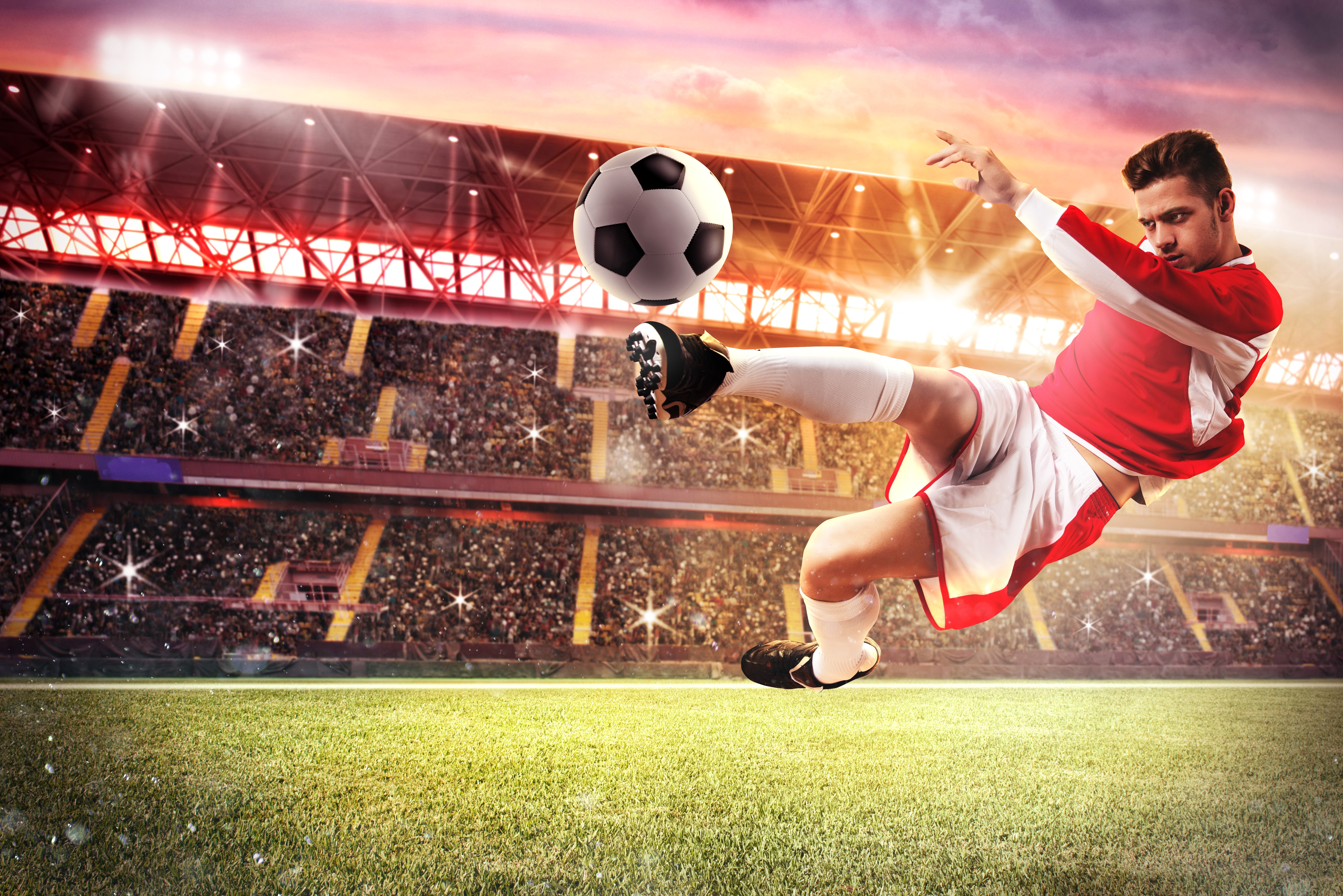 Man playing soccer in a stadium HD Wallpaper